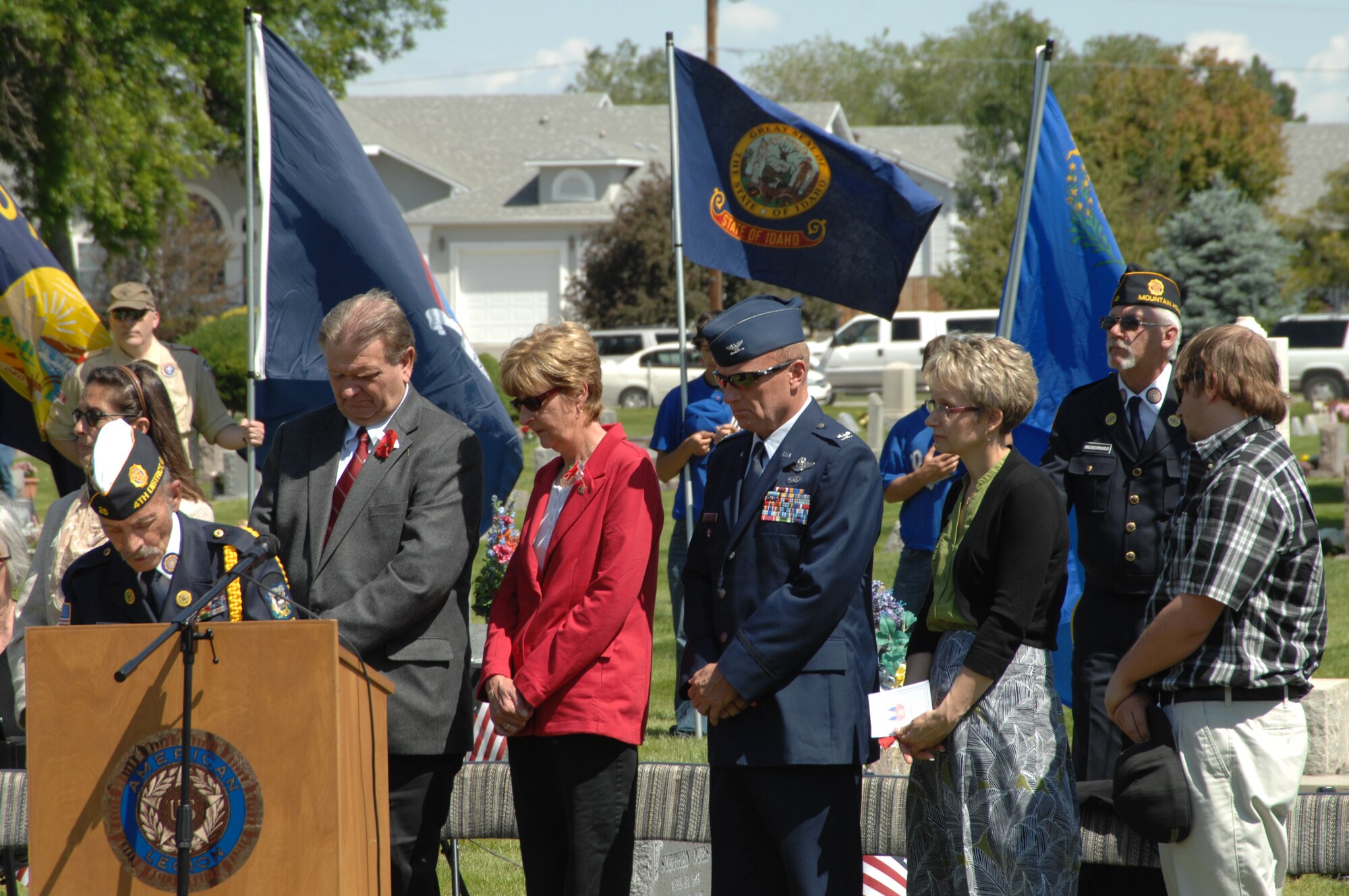 U.S. Air Force Col. Bruce Smith, 366th Fighter Wing vice commander, pauses with members of the local community during a portion of the Memorial Day ceremony May 28, 2012 at Mountain View Cemetery in Mountain Home, Idaho. Personnel from Mountain Home Air Force Base stood in formation throughout the ceremony as a visual reminder of the unique relationship the base has with the local community. (U.S. Air Force photo/ Senior Airman Benjamin Sutton) 