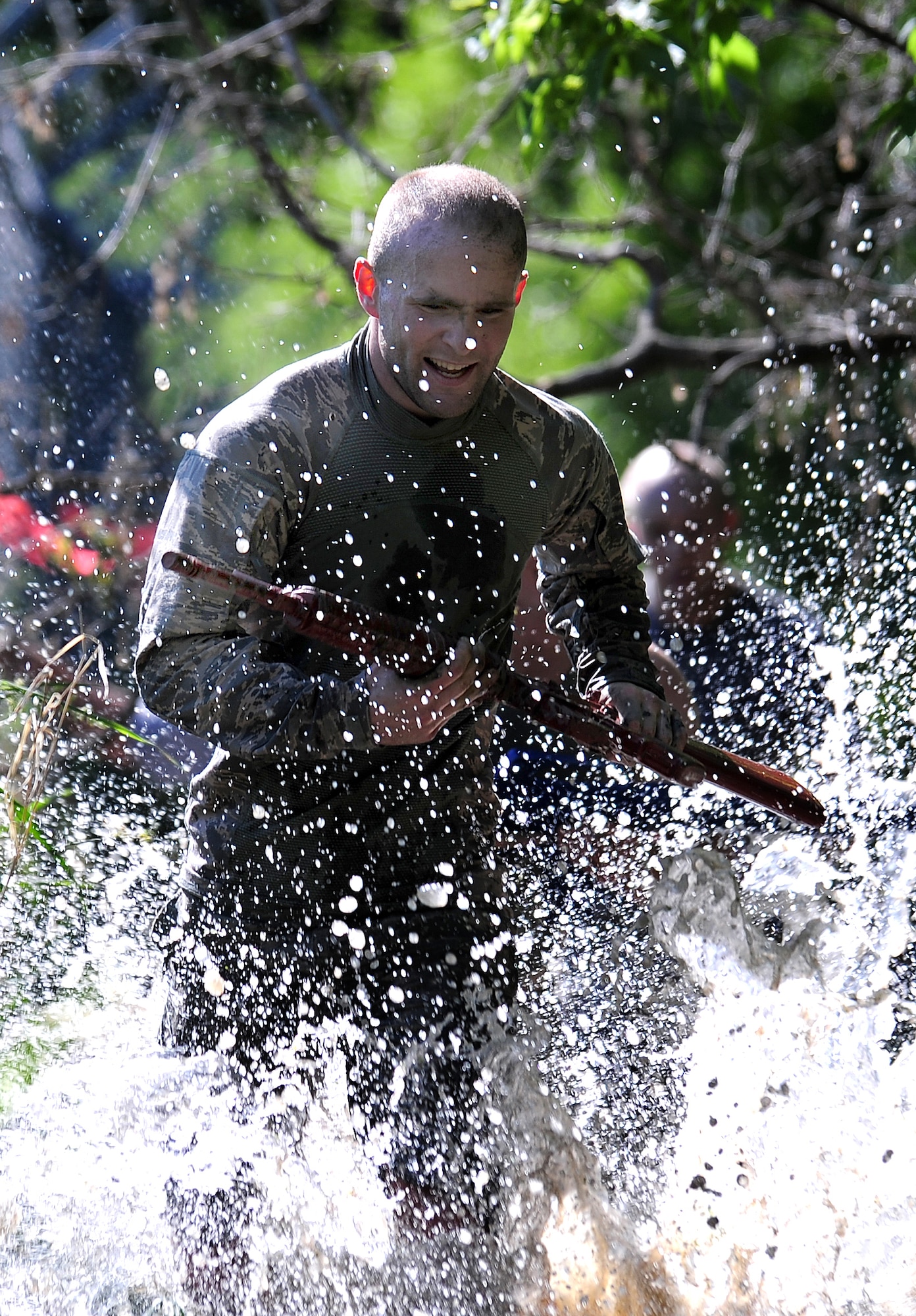 U.S. Air Force Airman 1st Class Christopher Whitton, 55th Security Forces Squadron, sprints through water as he makes his way through an "Evasion Challenge" put on by 55th SFS as part of National Police Week May 16 at Offutt Air Force Base, Neb. Jenkins and his team faced several obstacles in the challenge testing participants both physically and mentally.  (U.S. Air Force photo by Josh Plueger)