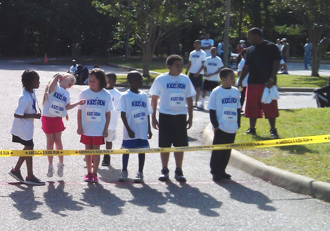 Children wait at the starting line to begin the 7-8 year-old's portion of the 2012 America's Armed Forces Kids Run at Fort Eustis, Va., May 19, 2012. Children as young as 4 and their families ran in honor of Armed Forces Day, joining thousands of other children across the globe on Army, Air Force, Navy and Marine Corps installations. (Photo courtesy/Caitlin Lavin)