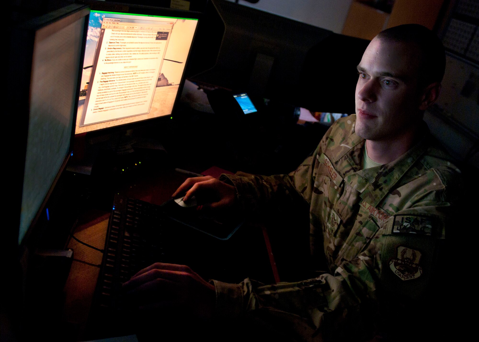 Staff Sgt. Peter Schueler, 455th Expeditionary Operations Support Squadron, noncommissioned officer in charge of current ops, compiles daily operational summaries on his computer from eight different squadrons on Bagram, to include daily flying schedules at Bagram Airfield, Afghanistan, 29 May, 2012. Schueler assisted in creating the new metric slides and the Situation Report database for the 455th Expeditionary Operations Group, allowing the critical metrics of eight squadrons to become automated across Bagram. (U.S. Air Force photo/Staff Sgt. Jeff Nevison)
