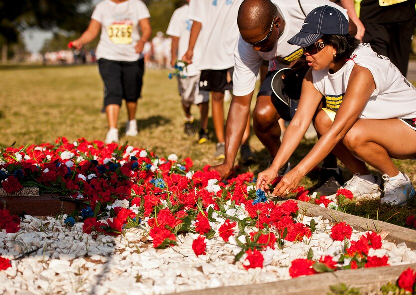 Runners pay their respects as they pass by the All Wars Memorial during the Gate-to-Gate run May 28 at Eglin Air Force Base, Fla.  More than 1,600 people ran in the annual Memorial Day event.  (U.S. Air Force photo/Samuel King Jr.)