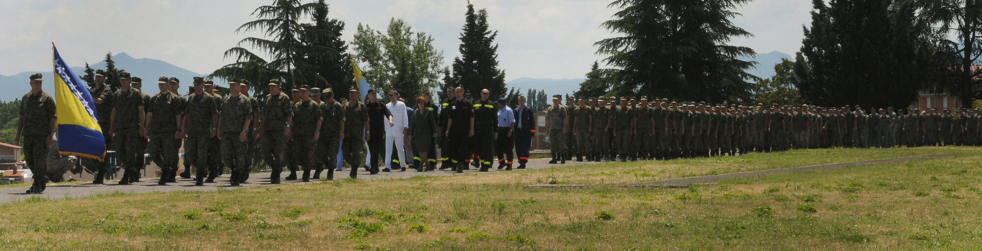 Particpants of Shared Resilience 2012 march to the parade field during the opening ceremony here May 28, 2012. More than 500 military members from nine nations are participating in the annual U.S. Joint Chiefs of Staff sponsored exercise May 28 - June 8. The goals of the exercise are to strengthen interoperability, facilitate training in crisis response and disaster management, and validate the readiness of deployable military medical and humanitarian assistance teams. The exercise, in the spirit of partnership for peace, directly supports U.S. European Command's theater cooperation efforts and strategy for active security with European countries.