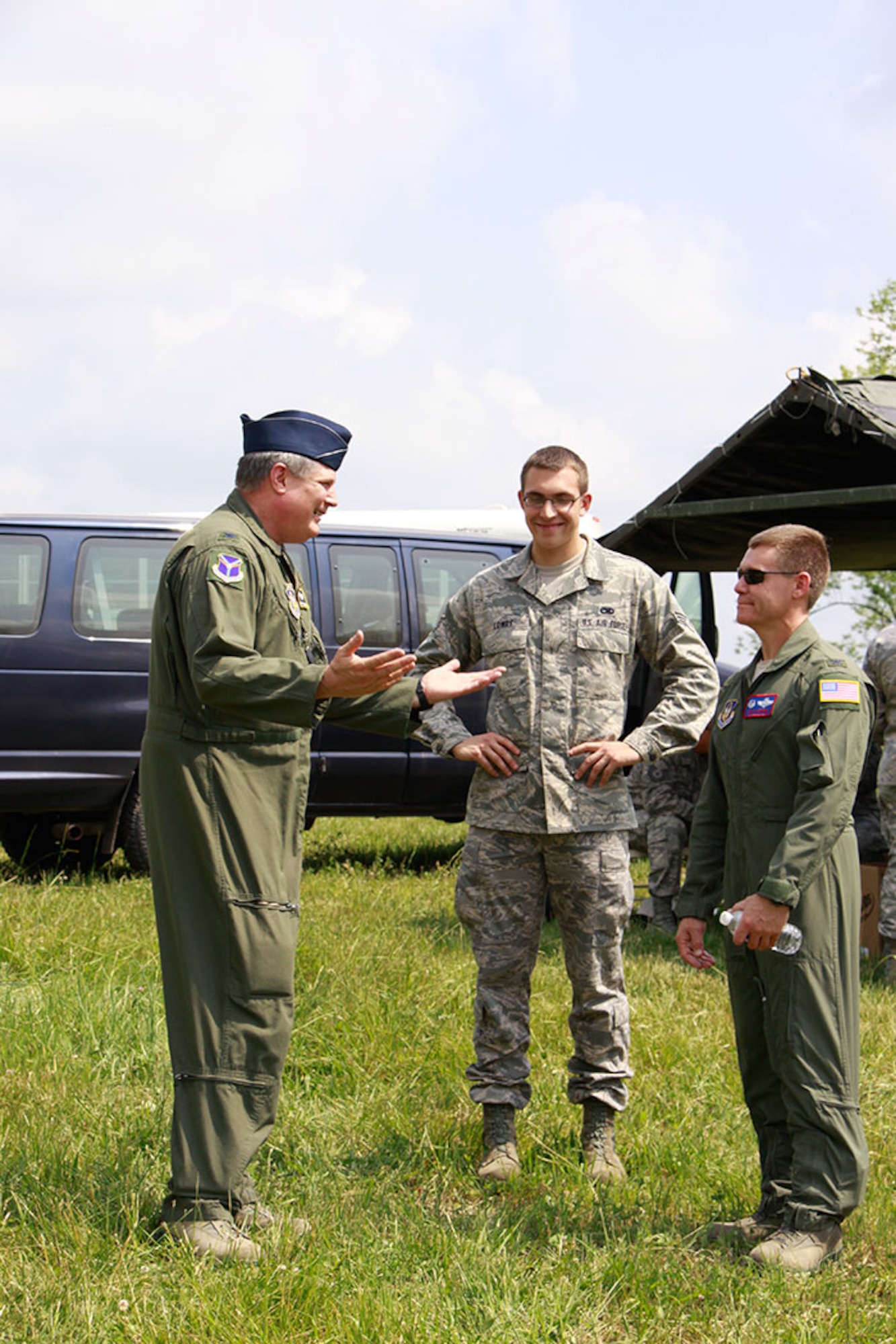 PITTSBURGH IAP ARS -- Senior Airman Benjamin J. Lowry (center), nephew to Col. Daryl J. Hartman
(left), 911th Airlift Wing Operations Group Commander, listens intently as
his uncle briefs the 911th AW Commander Col. Craig C. Peters (right) on the
expected drop times of cargo during the Honorary Commander's Association
event hosted by the 911th, May 23, 2012. Lowry, who is part of the 911th
Maintenance Squadron,  accompanied his uncle to the HCA event at the drop
zone in Burgettstown, Pa., to provide civic leaders with an "inside look" on
the role the 911th plays in the Air Force Reserve and surrounding community.
(U.S. Air Force photo by Airman 1st Class Justyne Obeldobel/Released)
