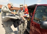 Airman 1st Class Jose Rangel, 22nd Civil Engineering Squadron fire protection specialist, speaks to Lt. Col. Dain Cleave, 22nd Maintenance Squadron commander, during the Child Safety Seat Workshop May 24, 2012, McConnell Air Force Base, Kan.  Parents from Team McConnell attended the workshop to have their car seats checked to ensure their child’s safety while on the road.  (U.S. Air Force photo/Airman 1st Class Maurice A. Hodges)