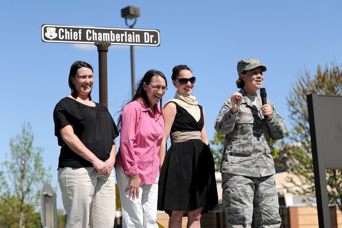 The daughters of retired Chief Master Sgt. Robert C. Chamberlain share a laugh during a ceremony held recently at Hancock Field Air National Guard Base during which a street was named in honor of their father. Chief Chamberlain served 32 years in the miliary, ending his career in the Civil Engineering Squardron at the 174th Fighter Wing.  The cermony was officiated by Maj. James Oaksford, the current CES Commander, who helped spearhead the effort to dedicate the street in Chief Chamberlain's honor.  (Photo by Tech. Sgt. Ricky Best/Released)