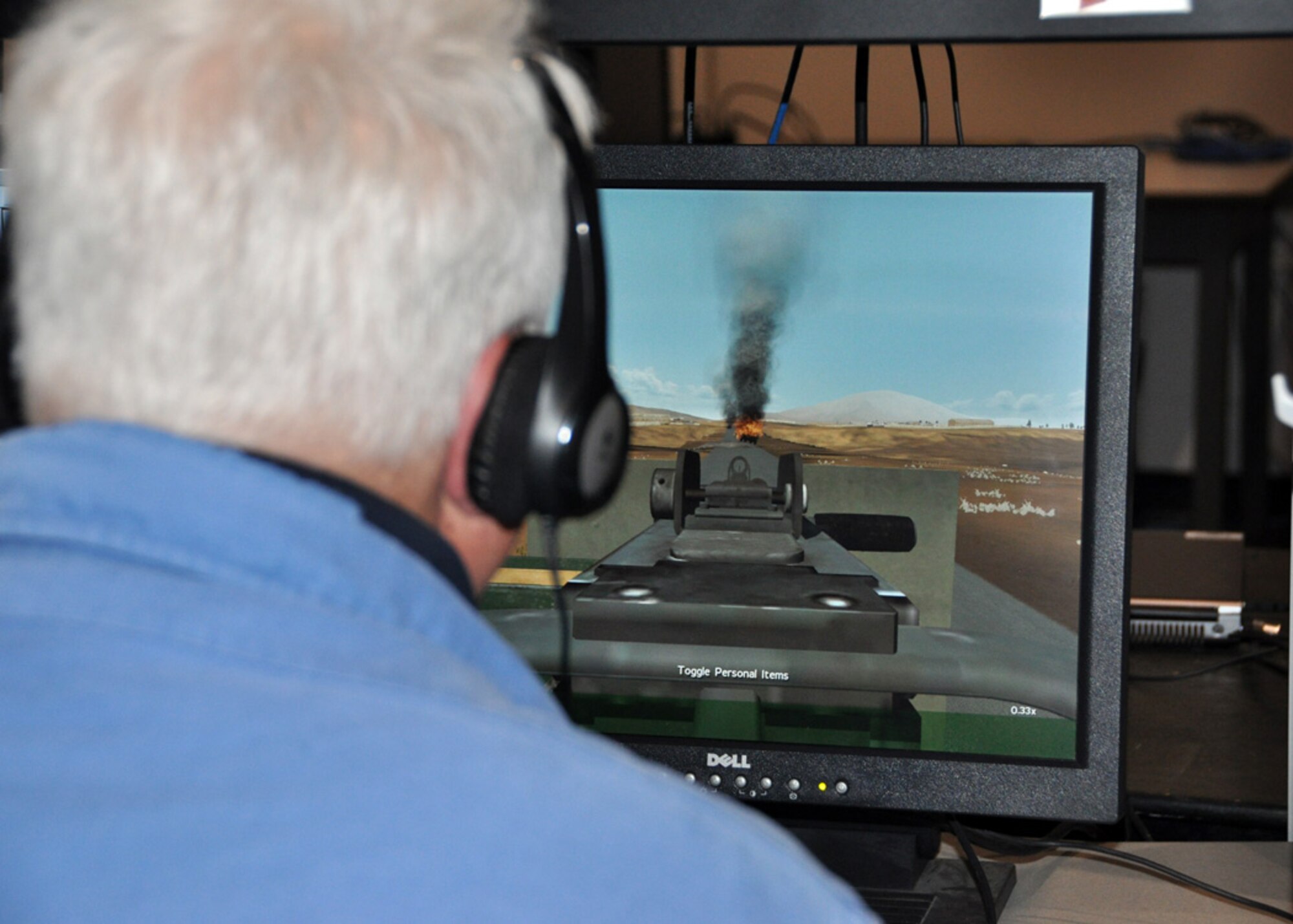 John Pugh, member of Employer Support of Guard Reserve, serves as a gunner during the Virtual Battle Station simulation at the Urban Warfare Center at Joint Base Lewis-McChord in Tacoma, Wash., during the 307th Bomb Wing/917th Fighter Group Civic Leader Tour May 23-24, 2012.  The purpose of the tour was to give local Shreveport-Bossier City civic leaders a broader understanding of what the Air Force Reserve is about and cultivate a relationship between the reservists and the community. (U.S. Air Force photo/Master Sgt. Mary Hinson)