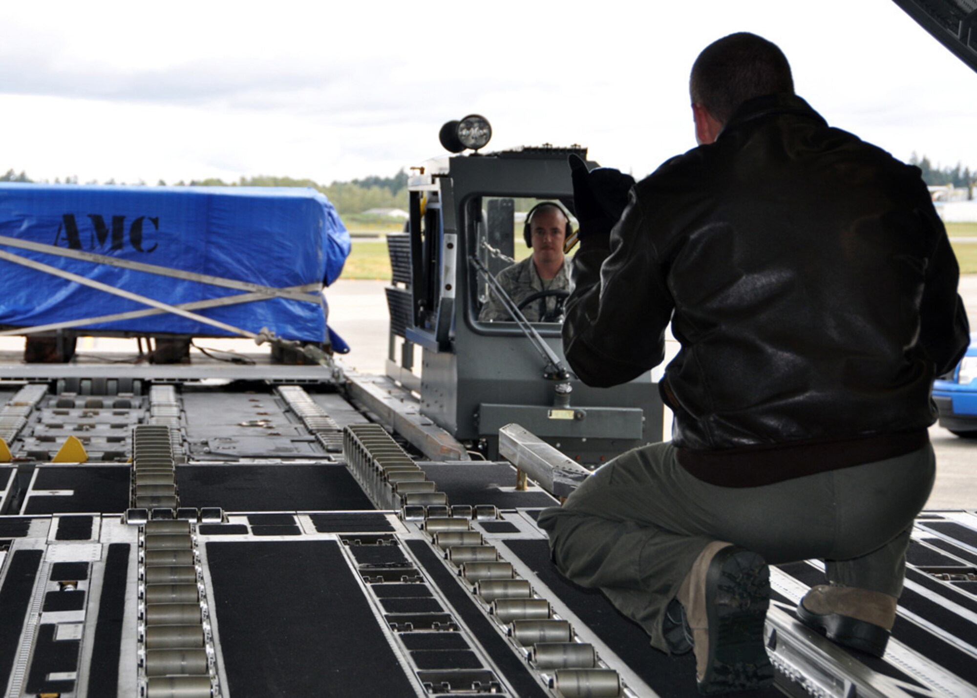 Members of the 446th Airlift Wing give a C-17 Globemaster loading demonstrations to the 307th Bomb Wing/917th Fighter Group civic leaders during a tour of Joint Base Lewis-McChord in Tacoma, Wash., May 23-24.  Other events included an aeromedical evacuation off-load, explosive ordnance disposal demonstration, training simulations, and a C-17 airdrop.  (U.S. Air Force photo/Master Sgt. Mary Hinson)