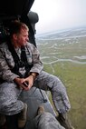 U.S. Air Force Capt. Daniel Roske surveys the New Jersey coastline from a New Jersey Army National Guard Black Hawk helicopter from the 1-150th Assault Helicopter Battalion on May 23 during an Employer Support of the Guard and Reserve event.  Roske, an Air Liaison Officer assigned to the 227th Air Support Operations Squadron, is a New Jersey Air National Guardsman, as well as an Ocean County Prosecuter's Office Detective.   U.S. Air Force photo/Tech. Sgt. Matt Hecht 