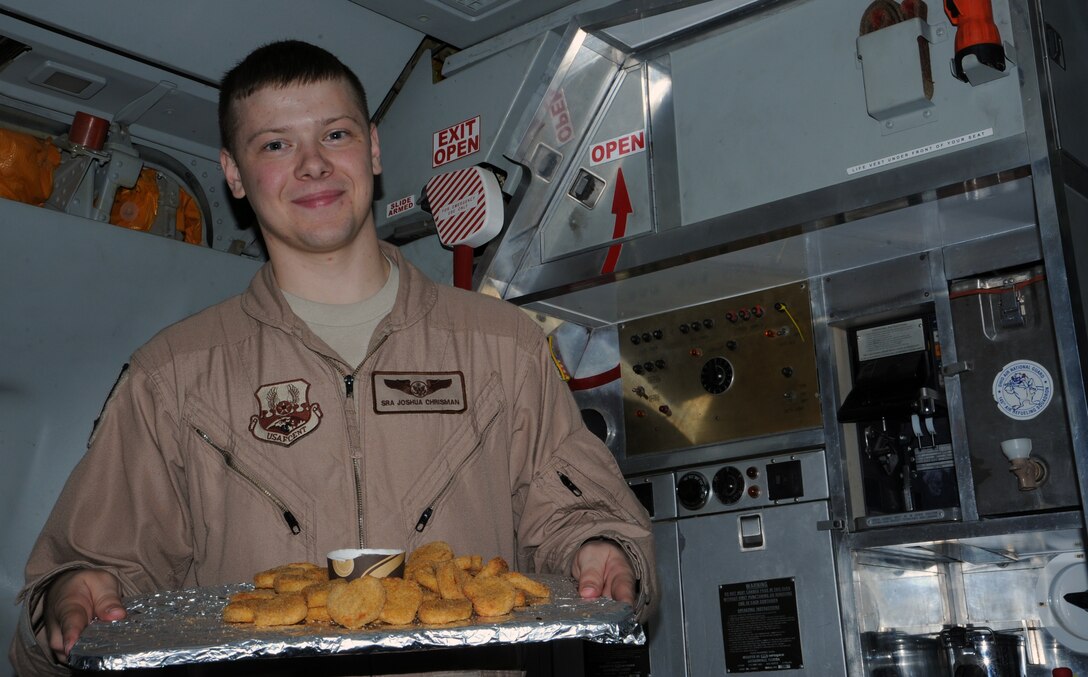 SOUTHWEST ASIA - Senior Airman Joshua Chrisman presents a platter of "victory nuggets" for his crew after a successful mission May 11, 2012. Chrisman, a KC-10 Extender boom operator, grew up an Air Force "brat" and knew he wanted to join the Air Force when he was old enough. The two-year Air Force veteran is deployed from Joint Base McGuire-Dix-Lakehurst, N.J., to the 908th Expeditionary Air Refueling Squadron. (U.S. Air Force photo/Staff Sgt. J.G. Buzanowski)
