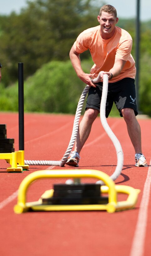 U.S. Air Force Senior Airman Jonathan Smith, 633rd Contracting Squadron contracting specialist, pulls a weighted sled in one of the events at the annual Squadron Fitness Challenge at Langley Air Force Base, Va., May 24, 2012.  Airmen took part in seven different physically-demanding events during the Squadron Fitness Challenge, held during May Fitness Month.  (U.S. Air Force photo by Airman 1st Class Kayla Newman/Released)
