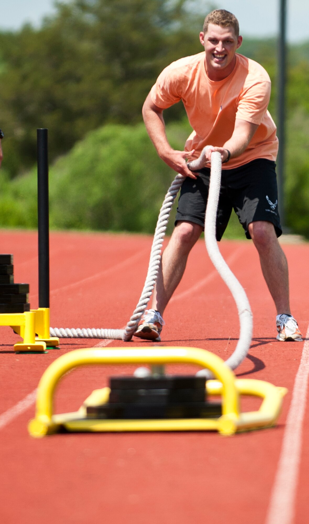 U.S. Air Force Senior Airman Jonathan Smith, 633rd Contracting Squadron contracting specialist, pulls a weighted sled in one of the events at the annual Squadron Fitness Challenge at Langley Air Force Base, Va., May 24, 2012.  Airmen took part in seven different physically-demanding events during the Squadron Fitness Challenge, held during May Fitness Month.  (U.S. Air Force photo by Airman 1st Class Kayla Newman/Released)