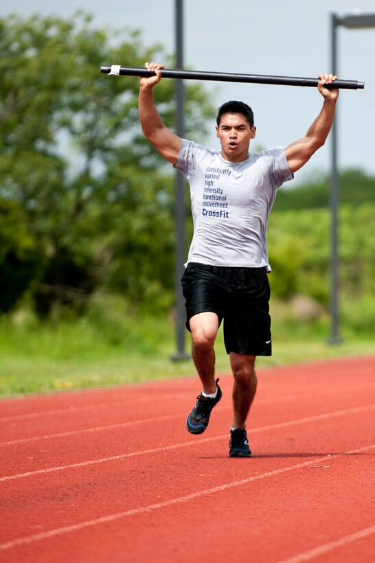U.S. Air Force 2nd Lt. Victor Delacruz, 633rd Force Support Squadron officer in charge of installation personnel and readiness, runs a 100-meter dash with a 17-pound bar during the annual Squadron Fitness Challenge event at Langley Air Force Base, Va., May 24, 2012.  The Squadron Fitness Challenge consisted of seven events designed to test physical strength and build camaraderie among units.  (U.S. Air Force photo by Airman 1st Class Kayla Newman/Released)
