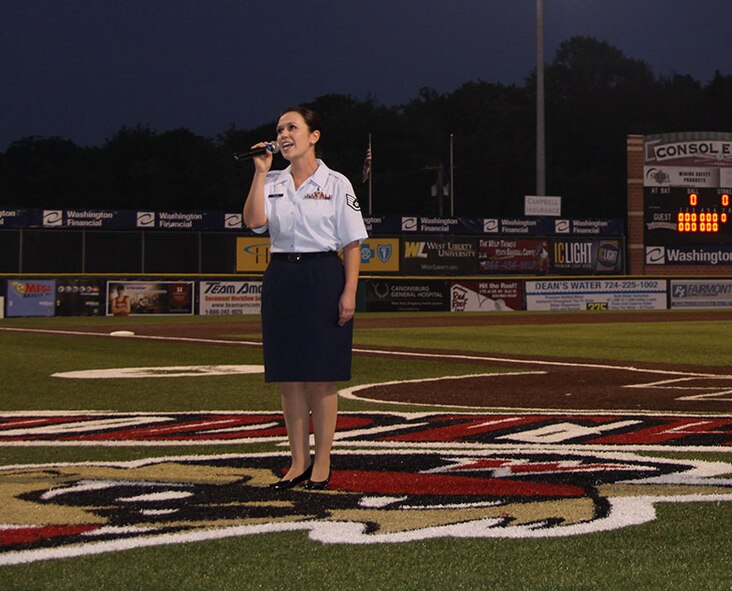 Staff Sgt. Jenna Black, of the 911th's Aeromedical Staging Squadron, sings God Bless America during the 7th inning stretch of the Washington Wild Things Home Opener, May 22, 2012. In addition to SSgt. Black singing God Bless America, Col. Craig C. Peters threw out the first pitch to Tech. Sgt. Stevan Hulick of the 32nd Aerial Port Squadron and the Unit’s Honor Guard carried out the colors before the National Anthem.  The Wild Things pulled ahead of the Gateway Grizzlies in the 10th inning, which ignited fireworks that capped off the success of their opening day.  (U.S. Air Force photo by Capt. Shawn M. Walleck/Released)