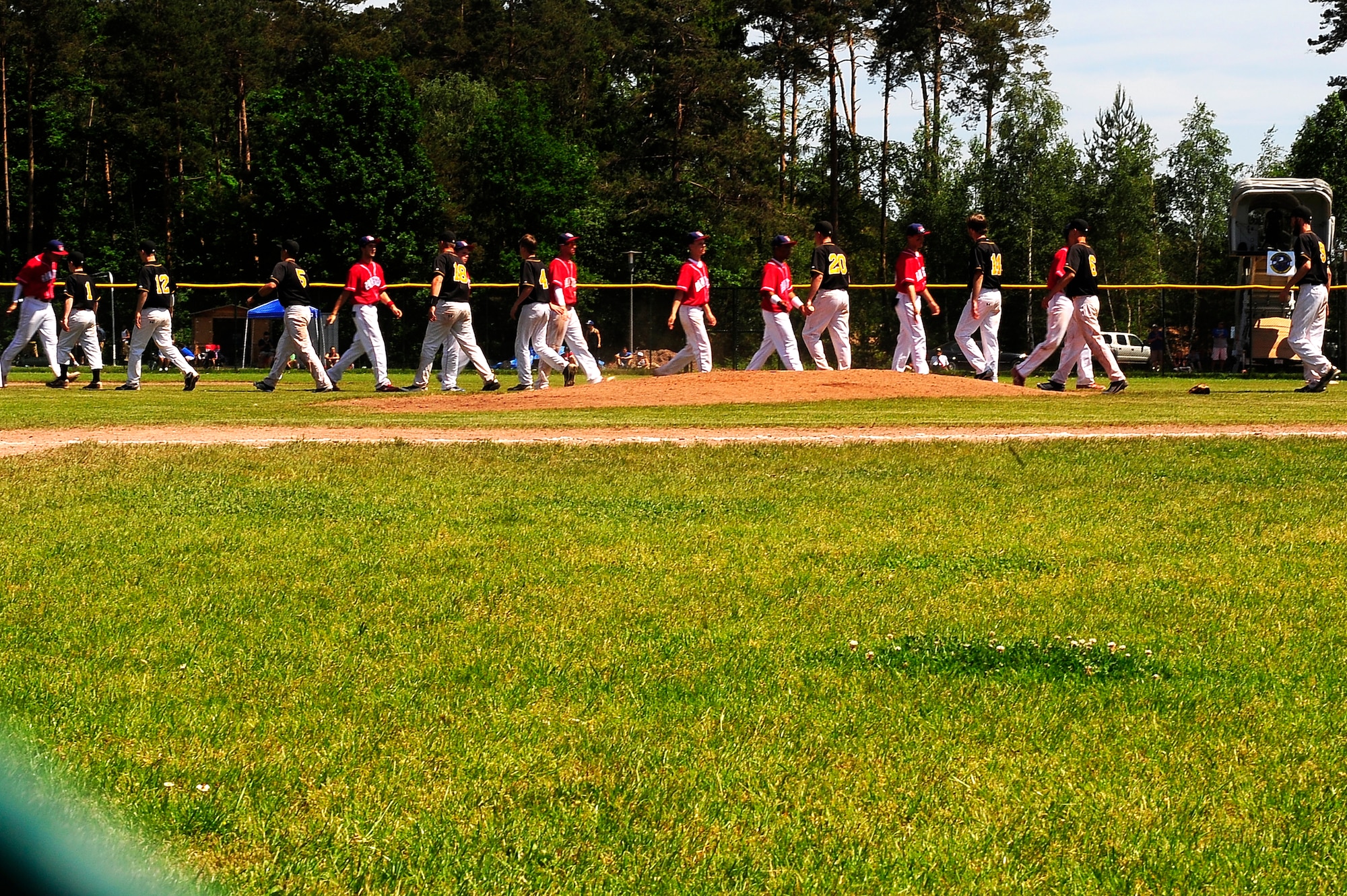 Two teams show sportsmanship after playing the Department of Defense Schools baseball championships game on Ramstein Air Base, Germany, May 29, 2012. The Panthers beat the Royals 7-2 earning their third-straight championship. (U.S. Air Force photo/ Senior Airman Aaron-Forrest Wainwright) 

