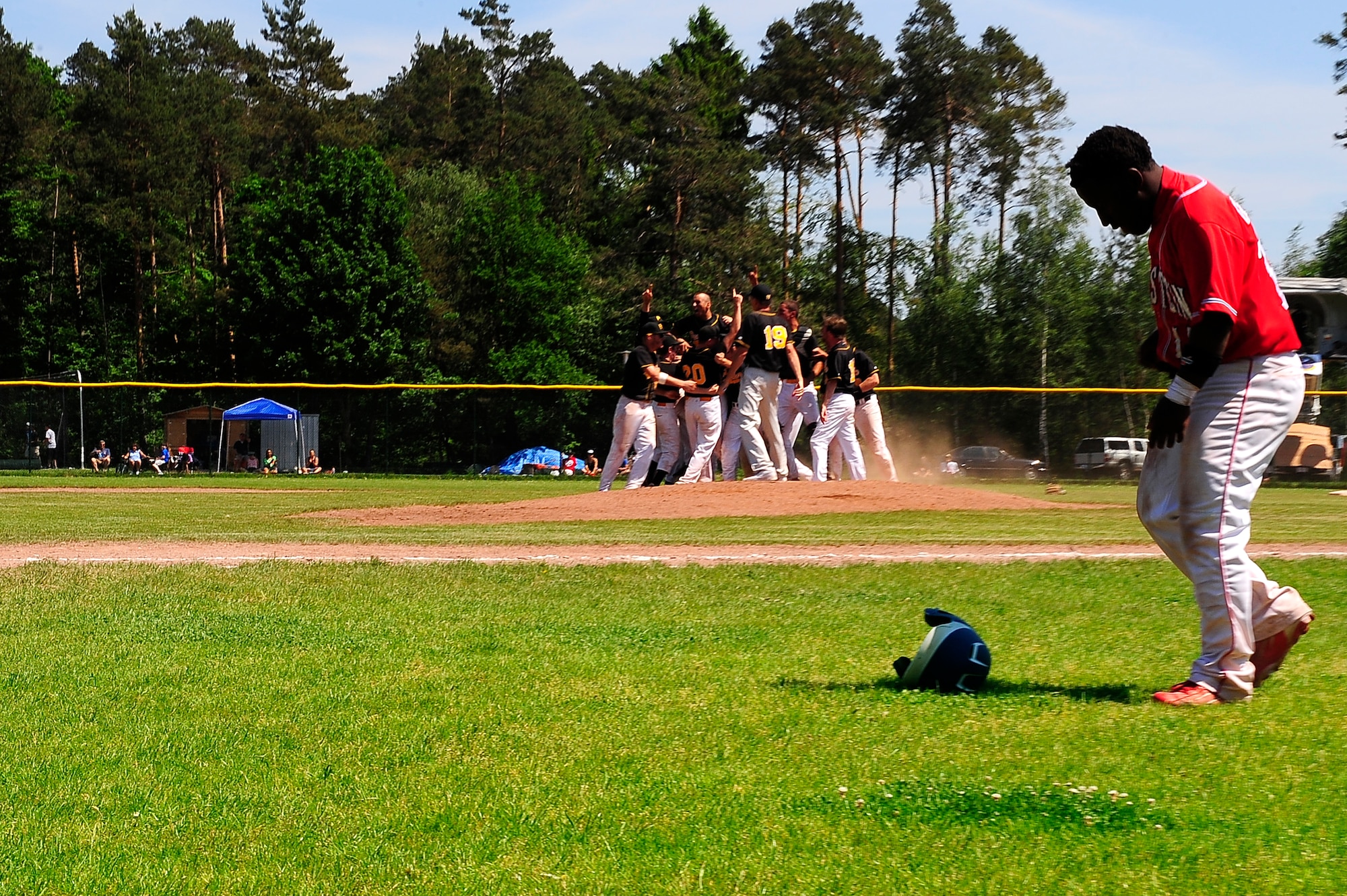 Stuttgart Panthers rush to the field in celebration after their victory of the Department of Defense Schools baseball championship on Ramstein Air Base, Germany, May 29, 2012. The Panthers beat the Ramstein Royals 7-2 earning their third-straight championship. (U.S. Air Force photo/ Senior Airman Aaron-Forrest Wainwright) 