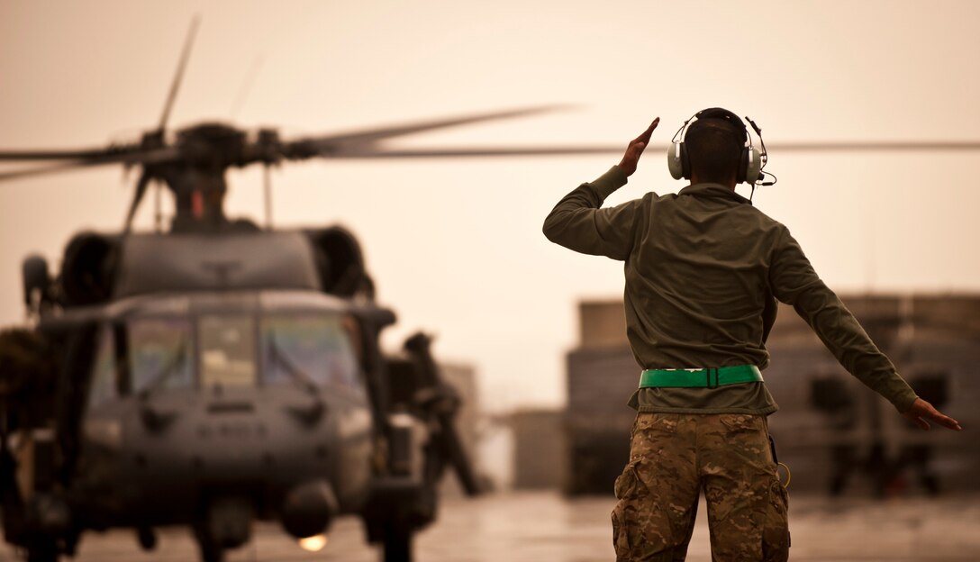 Senior Airman Robin Lu, maintainer assigned to the 33rd Expeditionary Helicopter Maintenance Unit, marshals a U.S. Air Force HH-60G Pave Hawk helicopter prior to take-off at Bagram Airfield, Afghanistan, May 25, 2012. Lu, a resident of Irvine, Calif., serves on a team of helicopter maintainers who enable Bagram’s Combat Search and Rescue capability in support of NATO and Afghan security forces. (U.S. Air Force photo/Capt. Raymond Geoffroy) 
