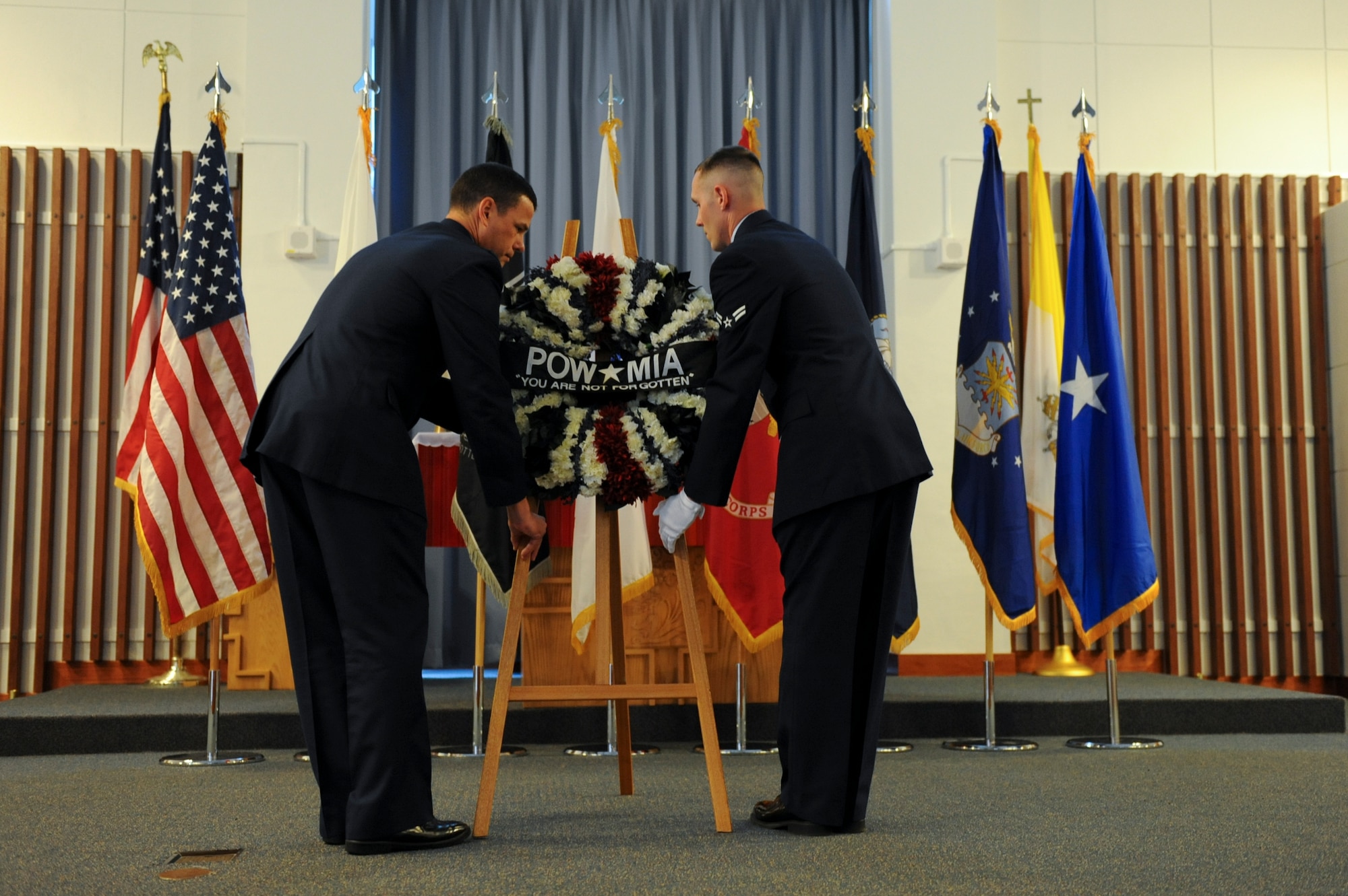 U.S. Air Force Brig. Gen. Matt Molloy, 18th Wing commander, and Airman 1st Class Jacob Jenkins, 18th Civil Engineer Squadron water and fuel system apprentice, present a wreath during a Memorial Day ceremony on Kadena Air Base, Japan, May 28, 2012. Although many see Memorial Day weekend as an opportunity to barbeque and be with family, it is important to remember those who paid the ultimate sacrifice. (U.S. Air Force photo/Airman 1st Class Brooke P. Beers)