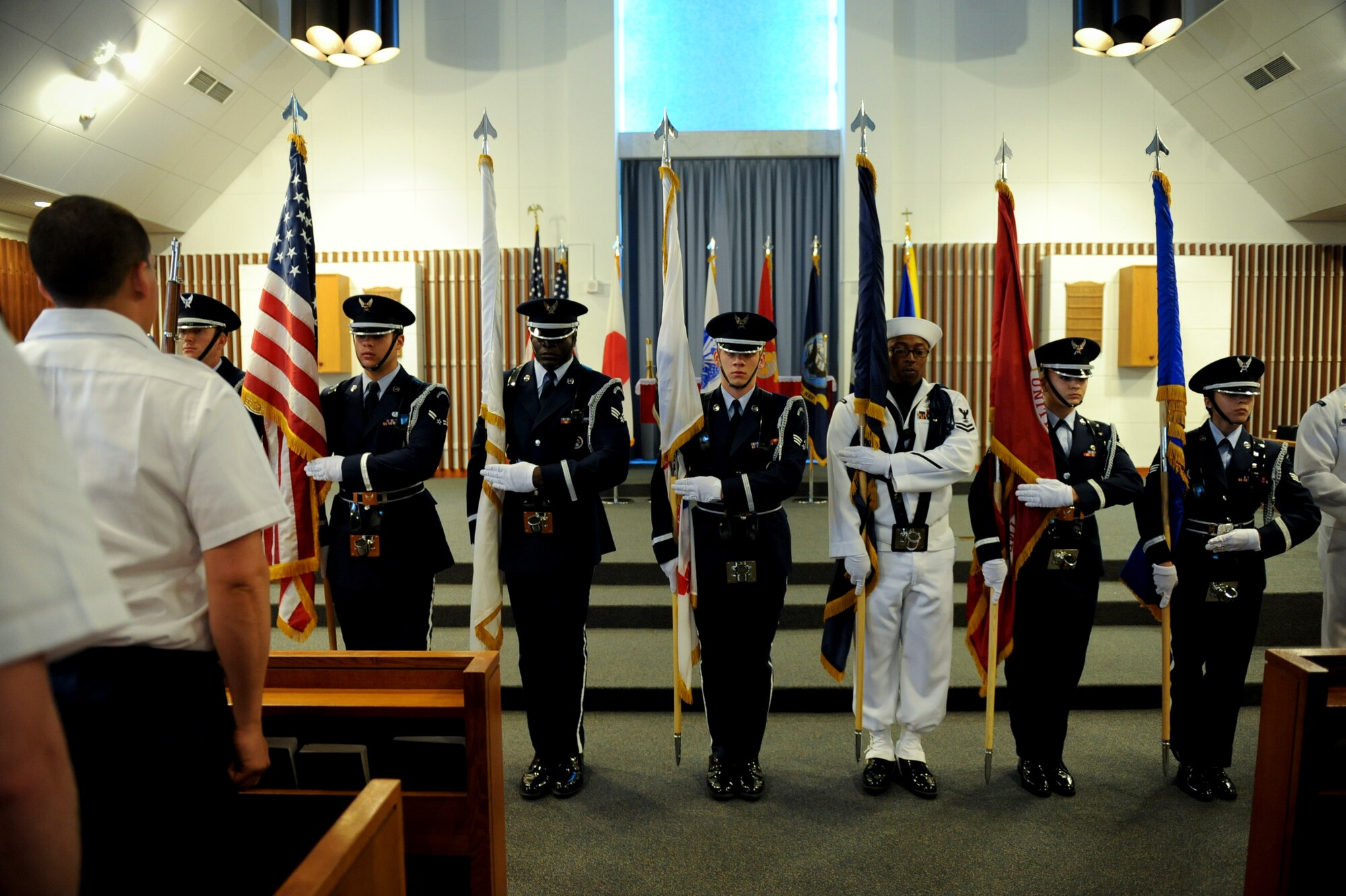 U.S. Air Force and Navy honor guardsmen present the colors during a Memorial Day ceremony at Chapel 1 on Kadena Air Base, Japan, May 28, 2012. More than a hundred service members, families and veterans attended the ceremony to remember Memorial Day. (U.S. Air Force photo/Airman 1st Class Brooke P. Beers)
