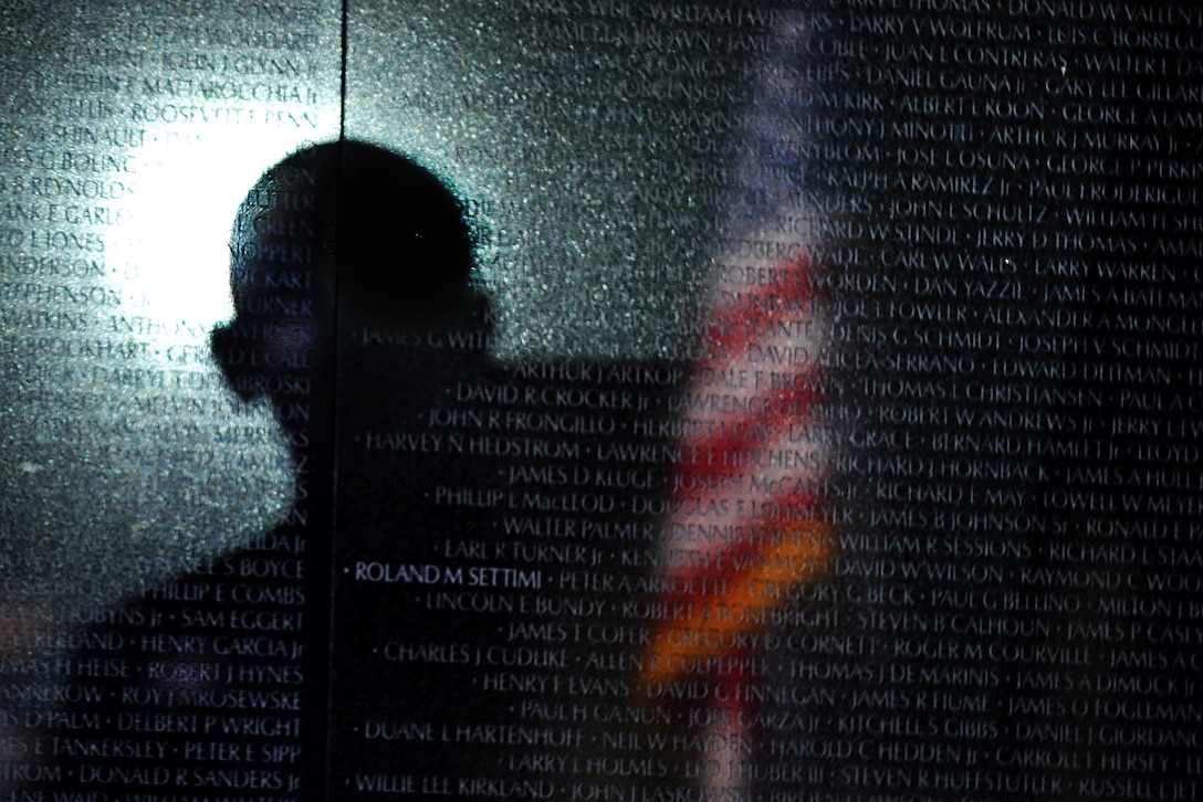 President Barack Obama cast a shadow as he delivers remarks during a ceremony commemorating the 50th anniversary of the Vietnam War at the Vietnam Veterans Memorial wall in Washington, D.C., May 28, 2012.