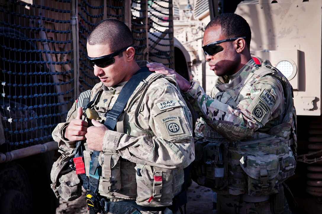 U.S. Army Spc. Michael Sanchez is helped into his harness by a buddy prior to a combat logistics patrol on Forward Operating Base Arian in Afghanistan's Ghazni province, May 26, 2012. Sanchez, a gunner, is assigned to the 82nd Airborne Division’s Company F, 2nd Battalion, 504th Parachute Infantry Regiment, 1st Brigade Combat Team.