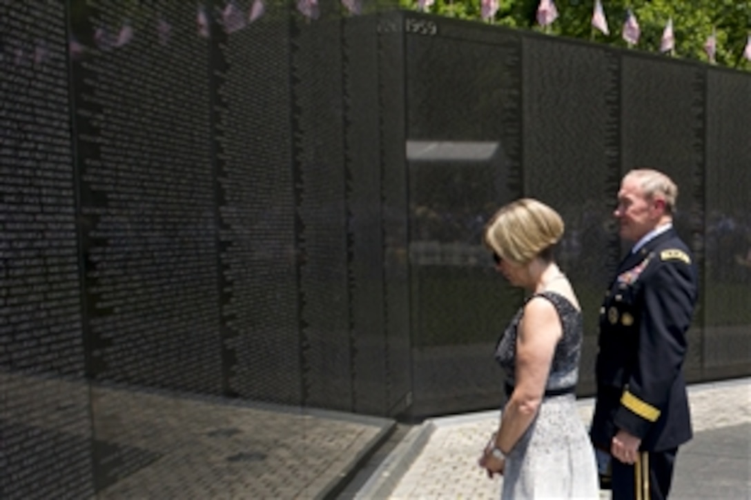Army Gen. Martin E. Dempsey, chairman of the Joint Chiefs of Staff, and his wife, Deanie, view the names of fallen troops on the Vietnam Veterans Memorial before the start of a Memorial Day ceremony in Washington D.C., May 28, 2012. 