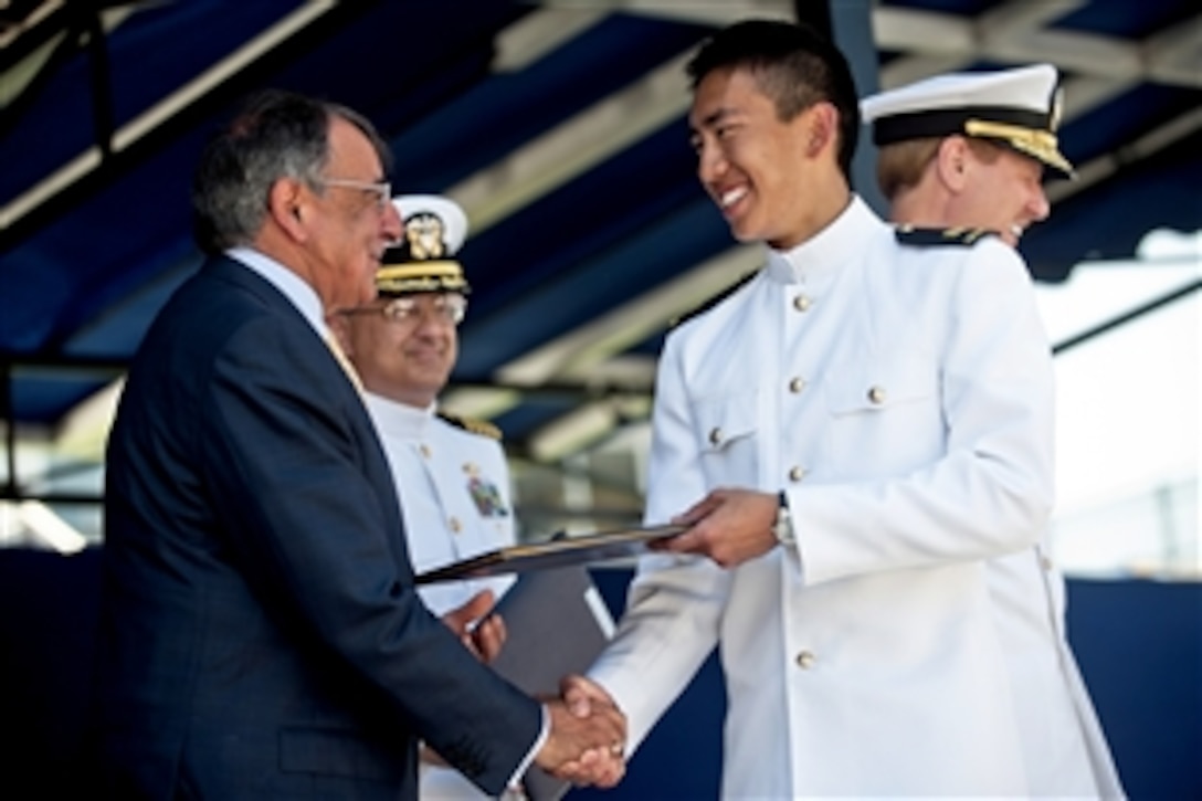 Defense Secretary Leon E. Panetta congratulates Midshipman Sam Tan Wei Shen, from Singapore, as he receives his diploma during the United States Naval Academy 2012 Graduation and Commissioning ceremony in Annapolis, Md., May 29, 2012. Shen is the first foreign student to earn the honor of top graduate in the academy's history.