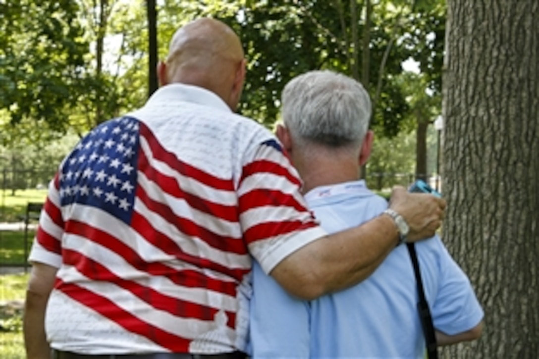 Barney Bidders, a retired soldier, and Les Newell, a retired Marine, both Vietnam War veterans from Virginia, recall memories of service at the Vietnam Veterans Memorial during a Memorial Day event at the wall in Washington, D.C., May 28, 2012.