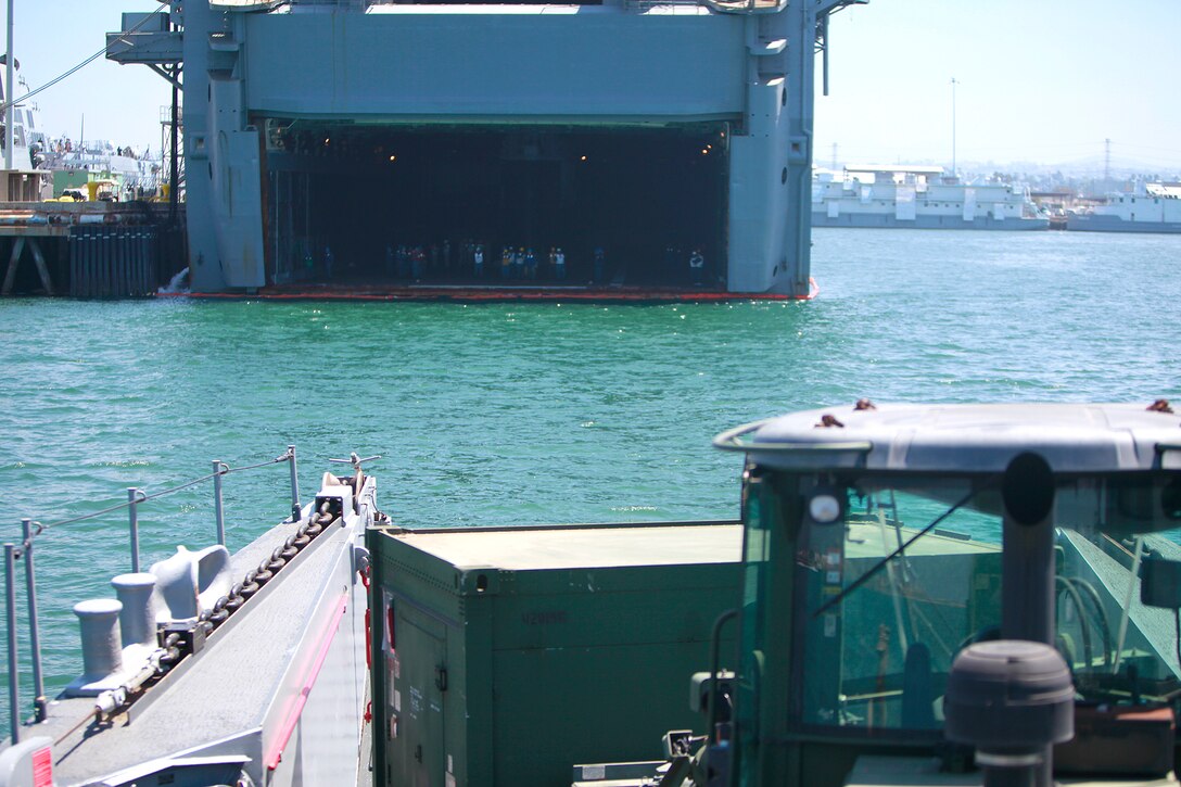 A landing craft utility prepares to load vehicles into the back of the USS Peleliu, here, May 29. Marines and sailors with the 15th MEU and Amphibious Squadron 3 began PHIBRON-MEU Interoperability, their first at-sea period as a full Marine Air-Ground Task Force, May 31. Before the training started, the 15th MEU’s embarkation specialists and landing support specialists with the Port Operations Group were tasked with loading the USS Peleliu and USS Rushmore with vehicles, equipment and cargo.