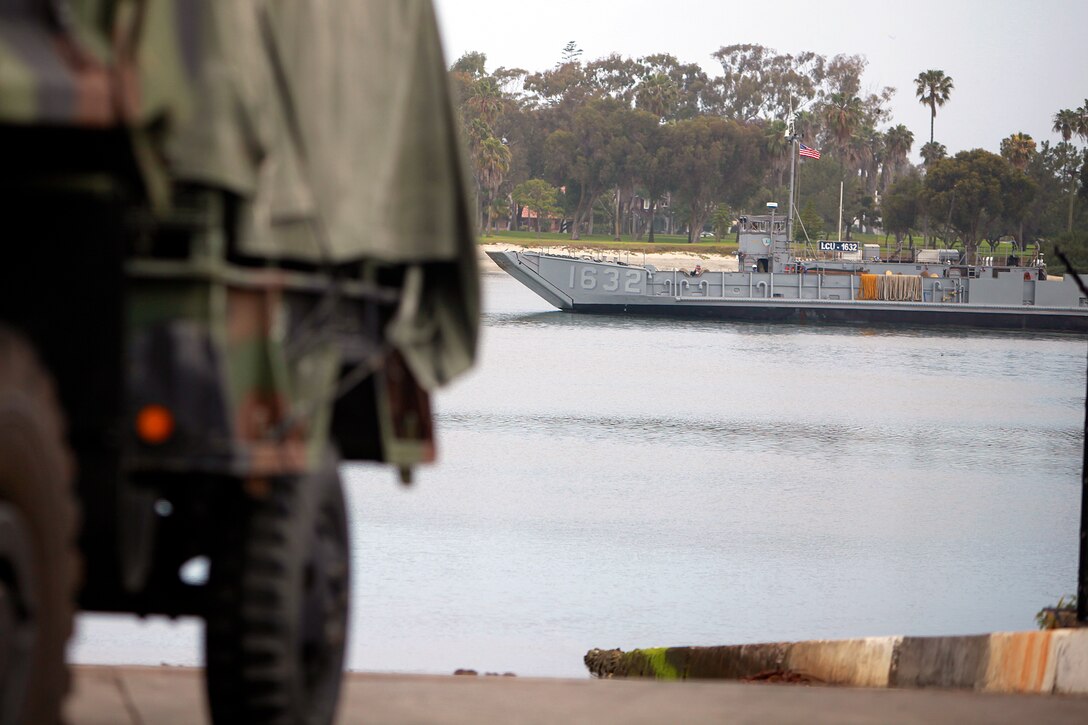 A landing craft utility pulls in to the loading dock, here, to load vehicles onto the USS Peleliu, May 29. Marines and sailors with the 15th MEU and Amphibious Squadron 3 began PHIBRON-MEU Interoperability, their first at-sea period as a full Marine Air-Ground Task Force, May 31. Before the training started, the 15th MEU’s embarkation specialists and landing support specialists with the Port Operations Group were tasked with loading the USS Peleliu and USS Rushmore with vehicles, equipment and cargo.