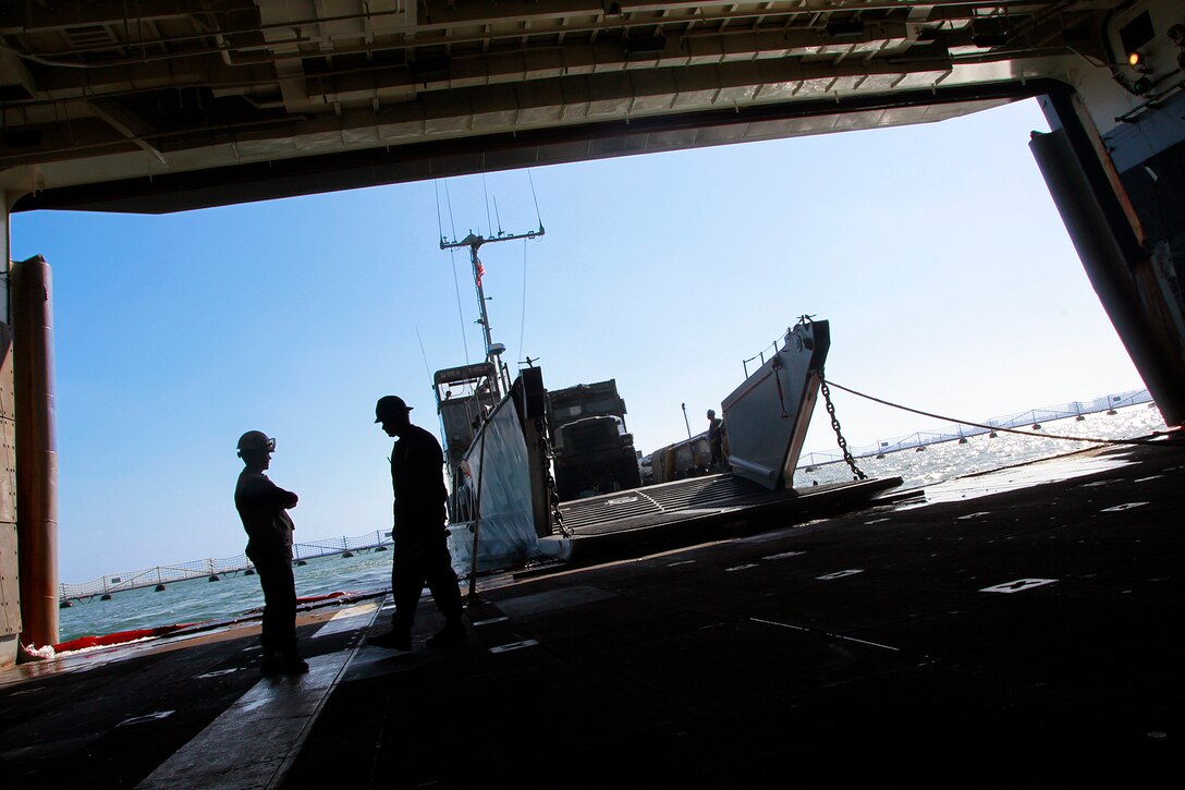 A landing craft utility unloads tactical vehicles onto the USS Peleliu as a part of the embarkation period, here, May 29. Marines and sailors with the 15th MEU and Amphibious Squadron 3 began PHIBRON-MEU Interoperability, their first at-sea period as a full Marine Air-Ground Task Force, May 31. Before the training started, the 15th MEU’s embarkation specialists and landing support specialists with the Port Operations Group were tasked with loading the USS Peleliu and USS Rushmore with vehicles, equipment and cargo.