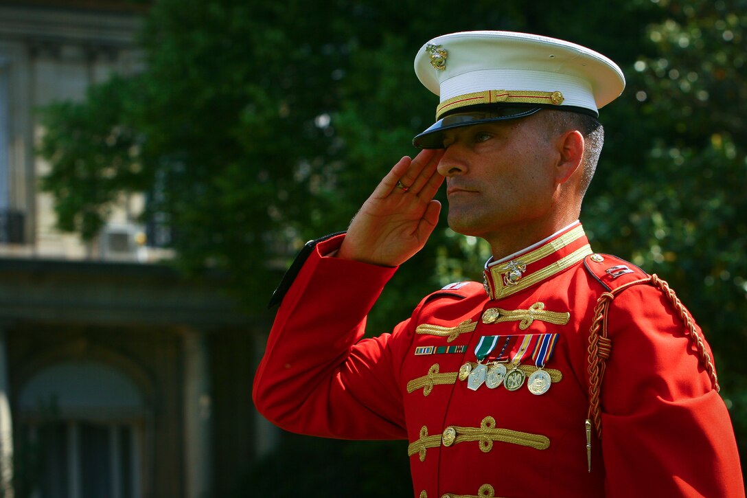 Capt. Christopher Hall, U.S. Marine Drum & Bugle Corps executive officer, salutes the crowd of guests during a Battle Color Ceremony at the American Ambassador's Residence in Paris May 29.