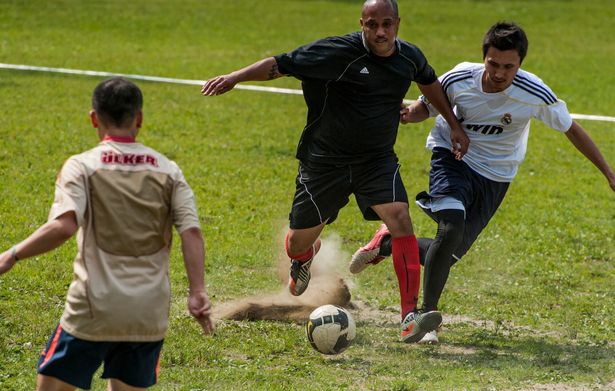 YOKOTA AIR BASE, Japan -- Soccer players compete for control over a soccer ball during a game at Airmen Appreciation Day at Yokota Air Base, Japan, May 29, 2012. (U.S. Air Force photo by Staff Sgt. Samuel Morse)