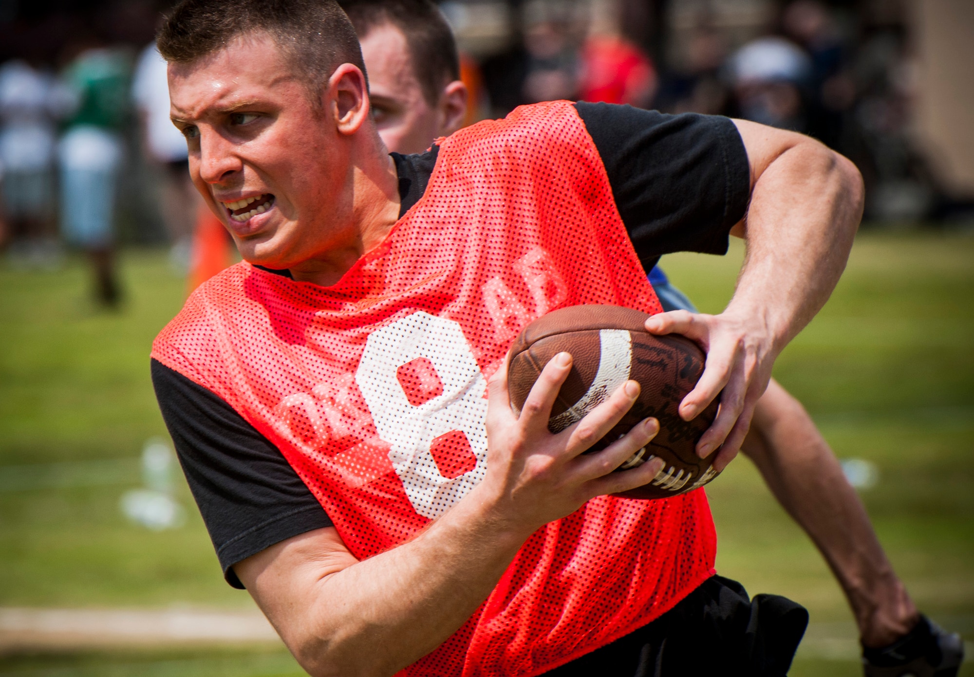 YOKOTA AIR BASE, Japan -- An Airman runs with a football during a flag football match as part of Airmen Appreciation Day at Yokota Air Base, Japan, May 29, 2012. (U.S. Air Force photo by Staff Sgt. Samuel Morse)
