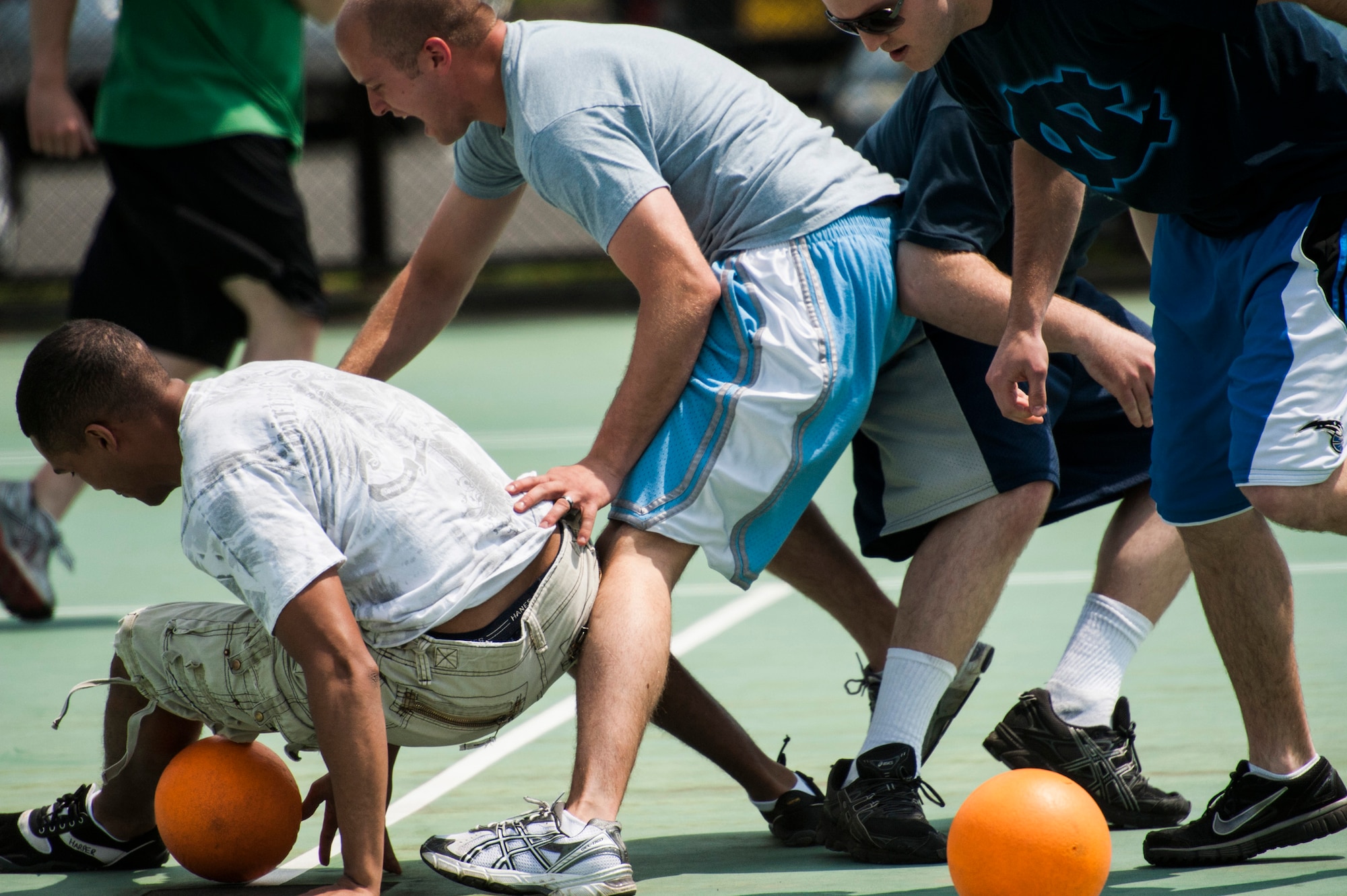 YOKOTA AIR BASE, Japan -- Dodgeball players scramble to get balls before their opposing teams do during a dodgeball tournament at Airmen Appreciation Day at Yokota Air Base, Japan, May 29, 2012. Sports representatives from the various units around Yokota organized teams to compete in sports such as dodgeball, soccer and flag football. (U.S. Air Force photo by Staff Sgt. Samuel Morse)