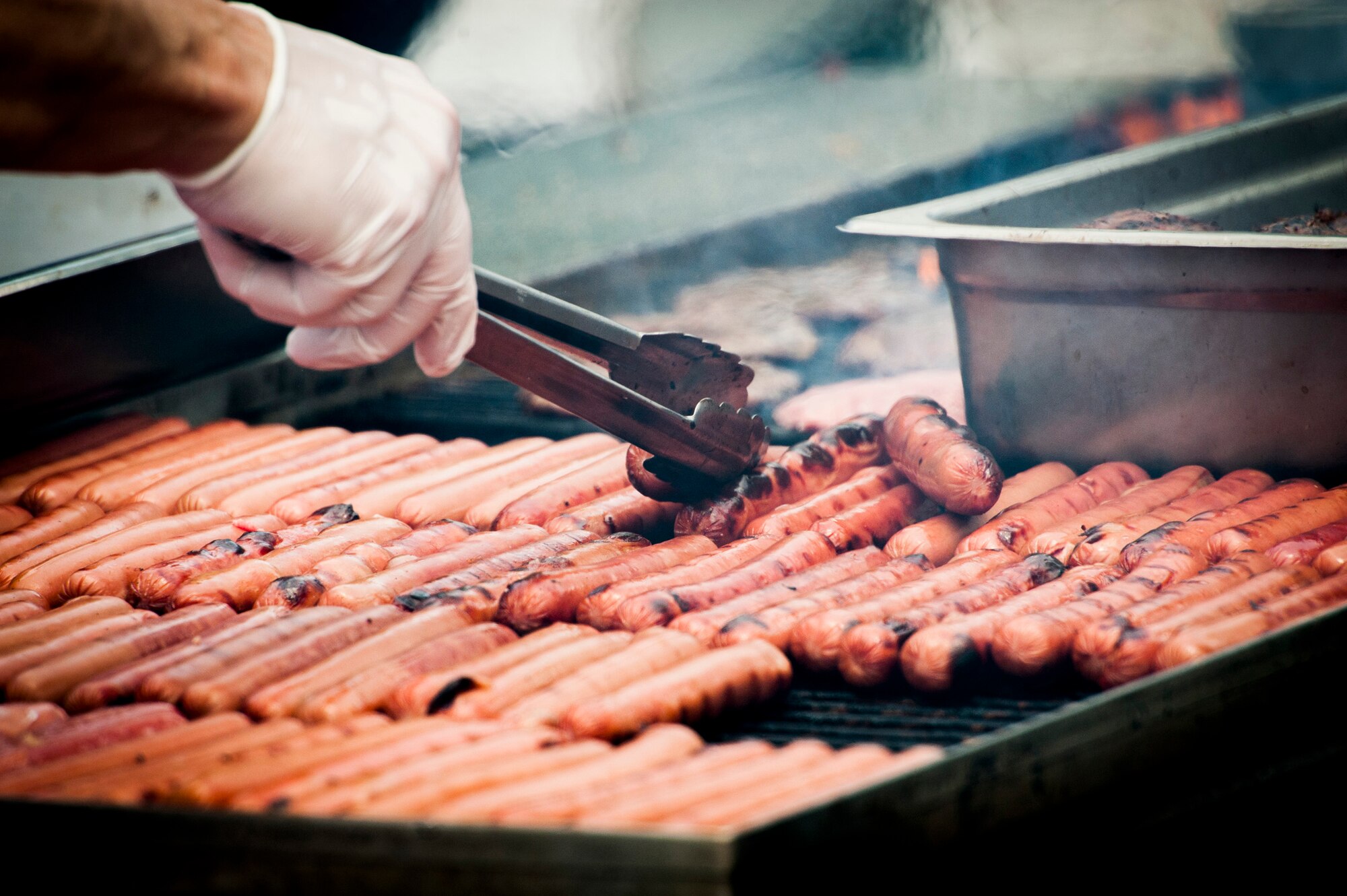YOKOTA AIR BASE, Japan -- A member of the Yokota Chiefs' Group turns hot dogs for Airmen Appreciation Day at Yokota Air Base, Japan, May 29, 2012. (U.S. Air Force photo by Staff Sgt. Samuel Morse)