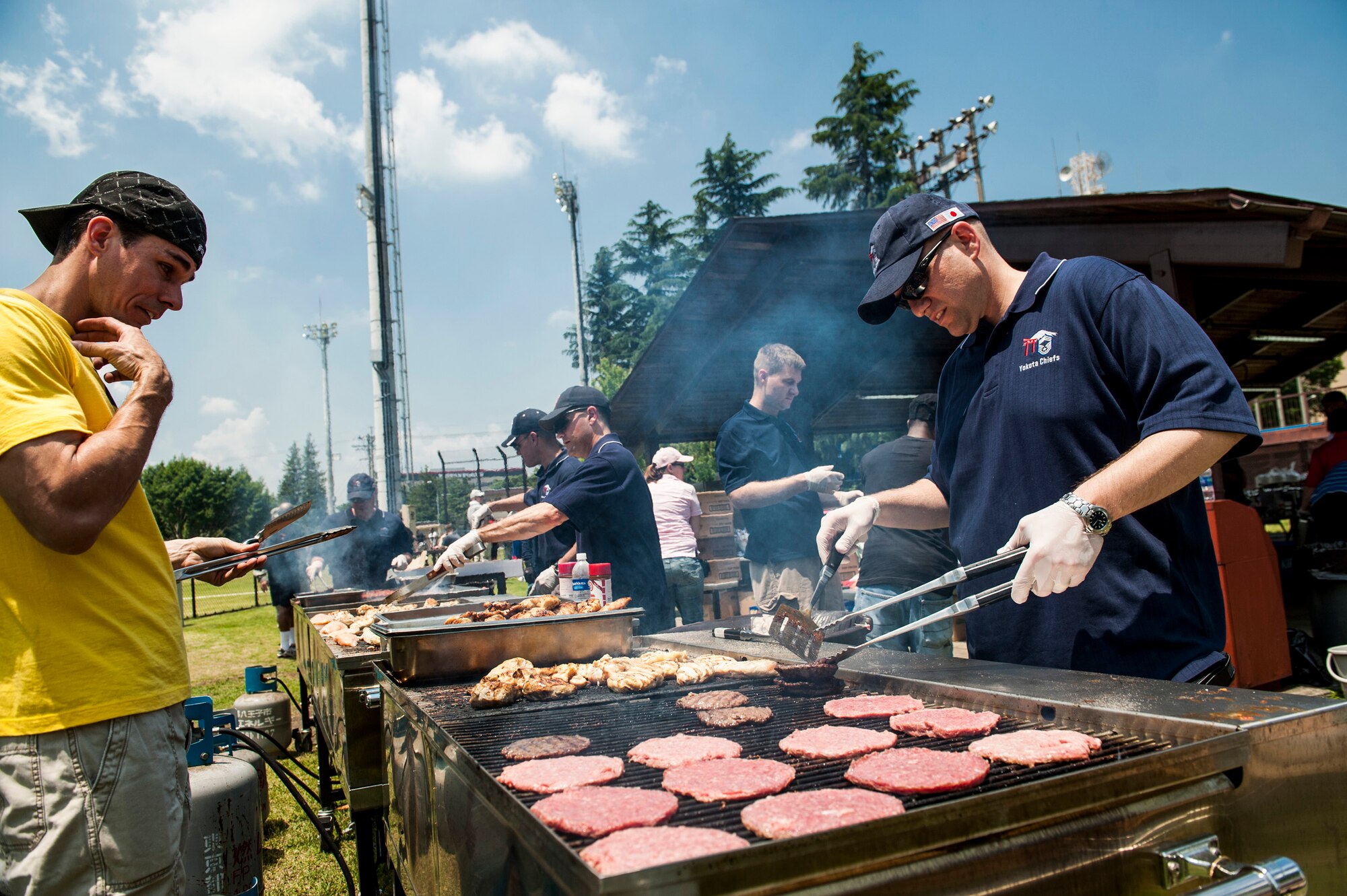 YOKOTA AIR BASE, Japan -- Members of the Yokota Chiefs' Group grill hamburgers, hot dogs and chicken for Airmen Appreciation Day at Yokota Air Base, Japan, May 29, 2012. (U.S. Air Force photo by Staff Sgt. Samuel Morse)