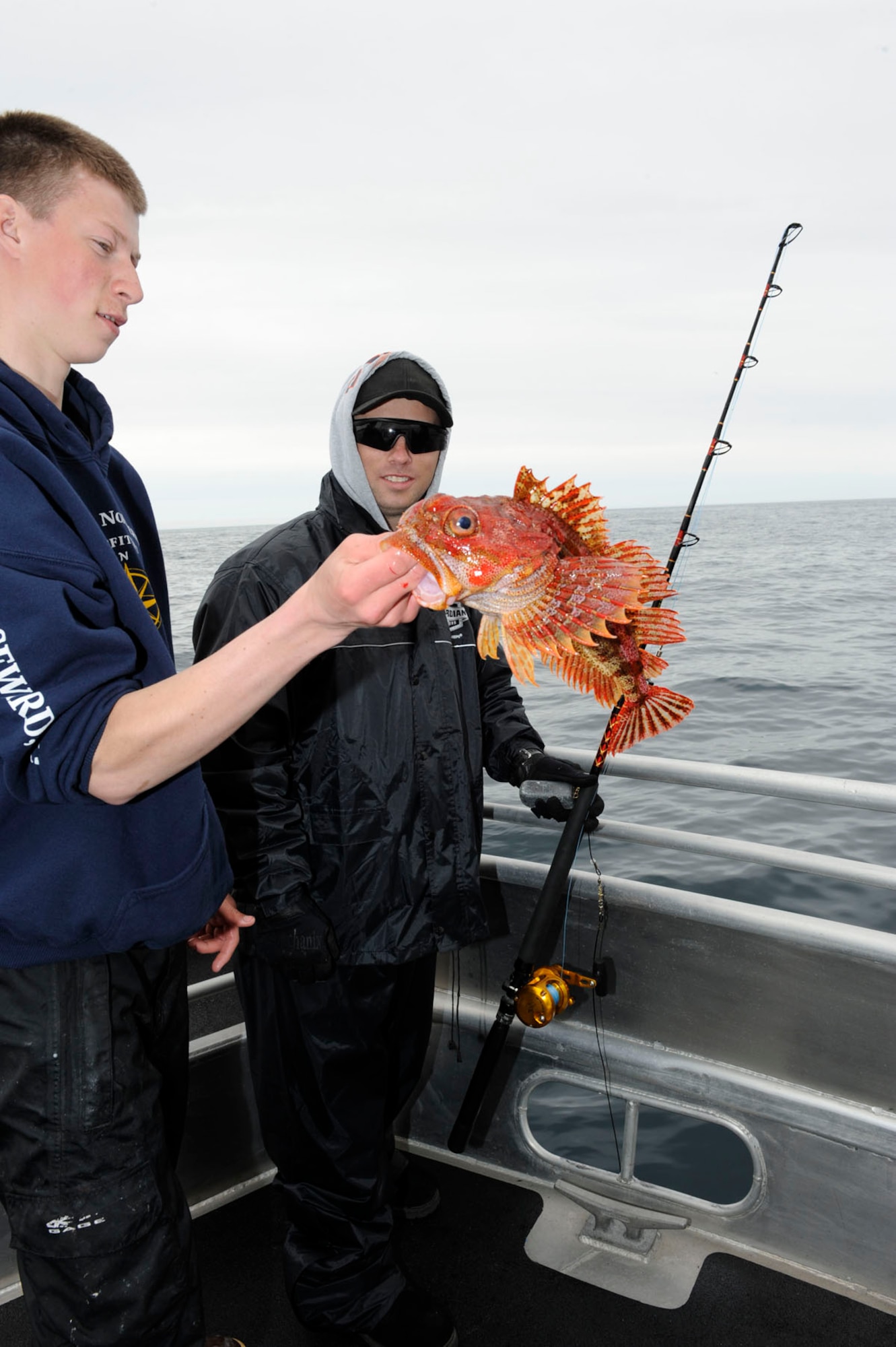 George Miles, left, and Army Staff Sgt. Robert Sanchez examine the rock fish that Sanchez caught during the Annual Armed Services Combat Fishing Tournament held at Seward, Alaska. Largely organized by the Armed Services YMCA, several fishing charters donated their services for the event, and over $50,000 in cash and prizes were awarded to everyone that participated in fishing. Miles is the 1st Mate of the Sea Quest charter and is native to Palmer, Alaska. Sanchez is a C-17 AV helicopter technician at Fort Wainwright and is native to Chicago, Ill. (U.S. Air Force photo/Staff Sgt. Robert Barnett)
