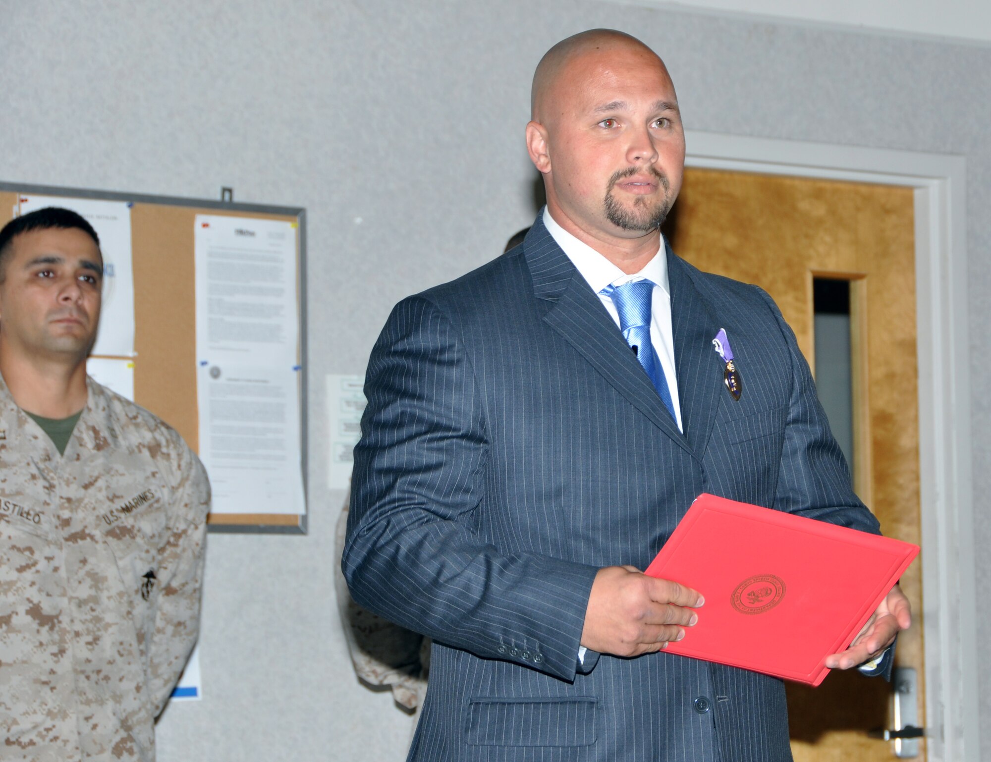 Marine Sgt. Monroe F. Seigle, a Georgia native, speaks to members of the Headquarters and Services Battalion about the importance of standing strong with one another. Seigle was presented his medal at a ceremony on May 30 at the Navy Operations Support Center on Dobbins Air Reserve Base. (U.S. Air Force photo/Senior Airman Elizabeth Gaston/Released)