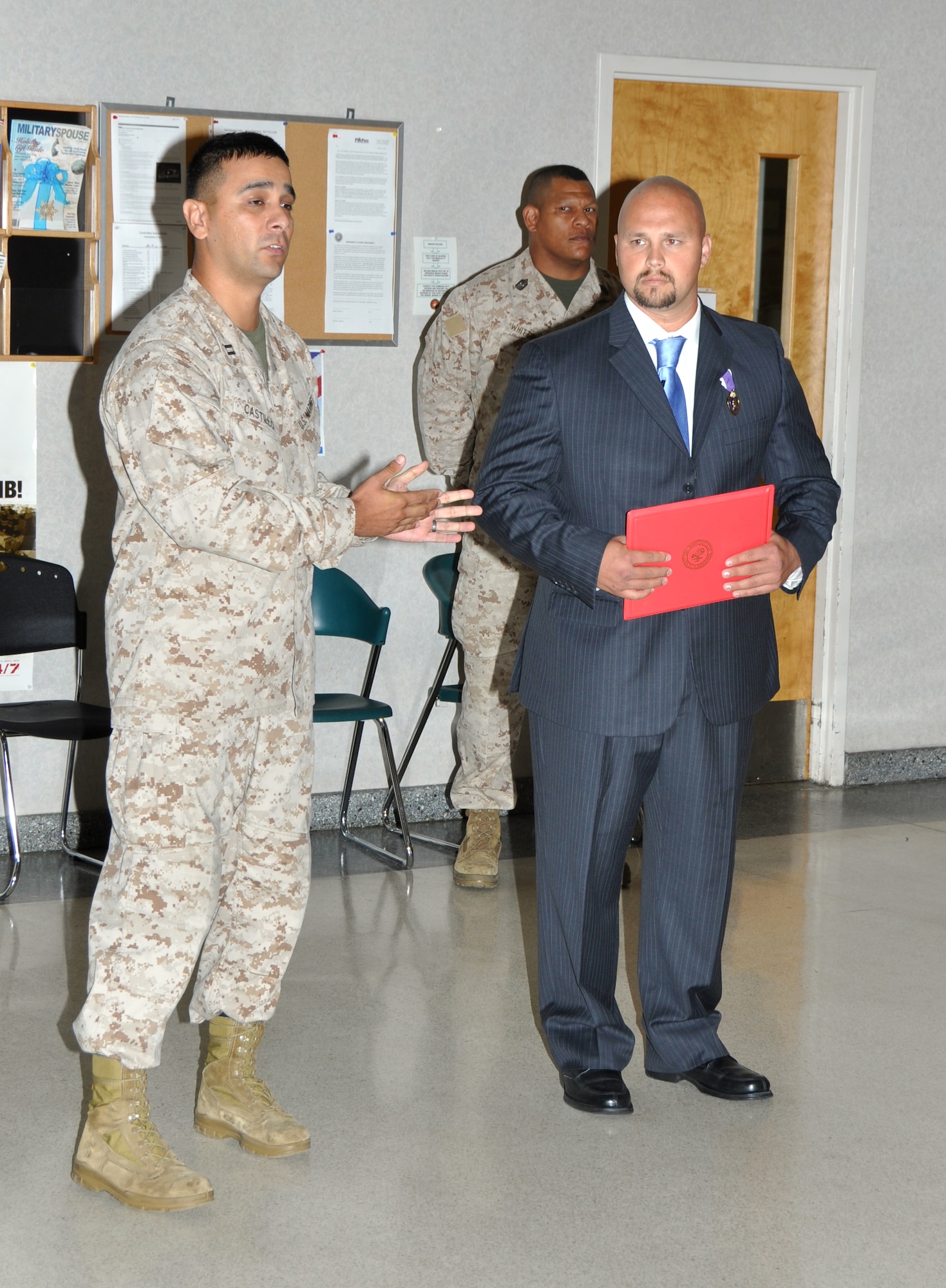 Marine Capt. Jason Castillo, Headquarters and Services Battalion, 4th Marine Logistics Group executive officer, speaks about the significance of Marine Sgt. Monroe F. Seigle, a Georgia native, receiving his Purple Heart to members of the Headquarters and Services Battalion. Seigle was presented his medal at a ceremony on May 30 at the Navy Operations Support Center on Dobbins Air Reserve Base. (U.S. Air Force photo/Senior Airman Elizabeth Gaston/Released)