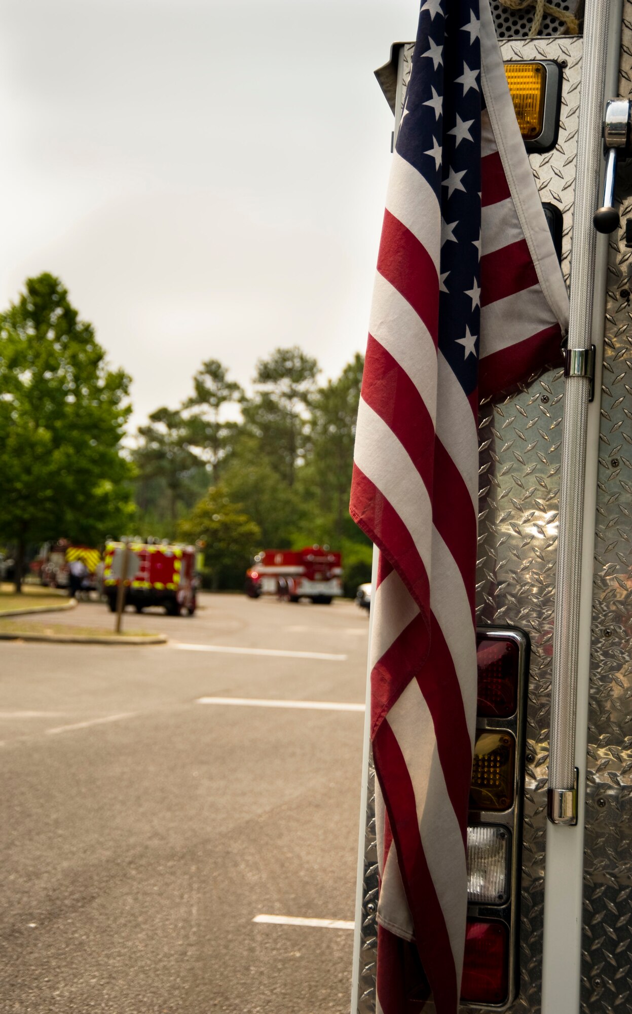 A U.S. flag hangs from a fire truck at the mobile operations center housed at Northwest Florida State College at Fort Walton Beach, Fla., May 30, 2012.  Fire stations from the local community are all assisting in attempts to distinguish a local wildfire affecting the area. (U.S. Air Force Photo/Airman 1st Class Naomi M. Griego/RELEASED)