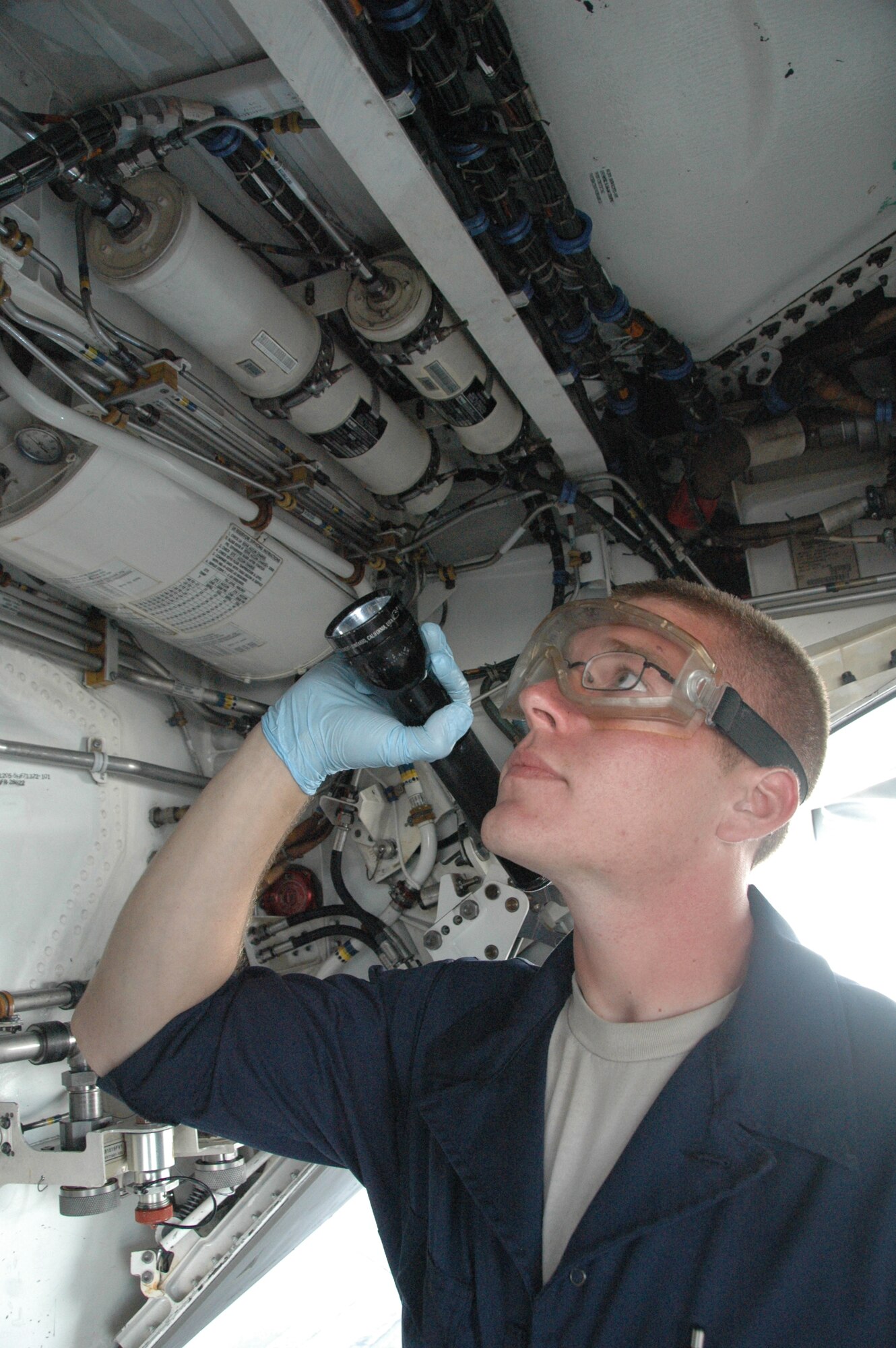 Senior Airman Marc Billings, 43rd Aircraft Maintenance Unit crew chief, inspects an F-22 as part of a routine procedure May 22. (U.S. Air Force photo by Senior Airman Rachelle Elsea)
