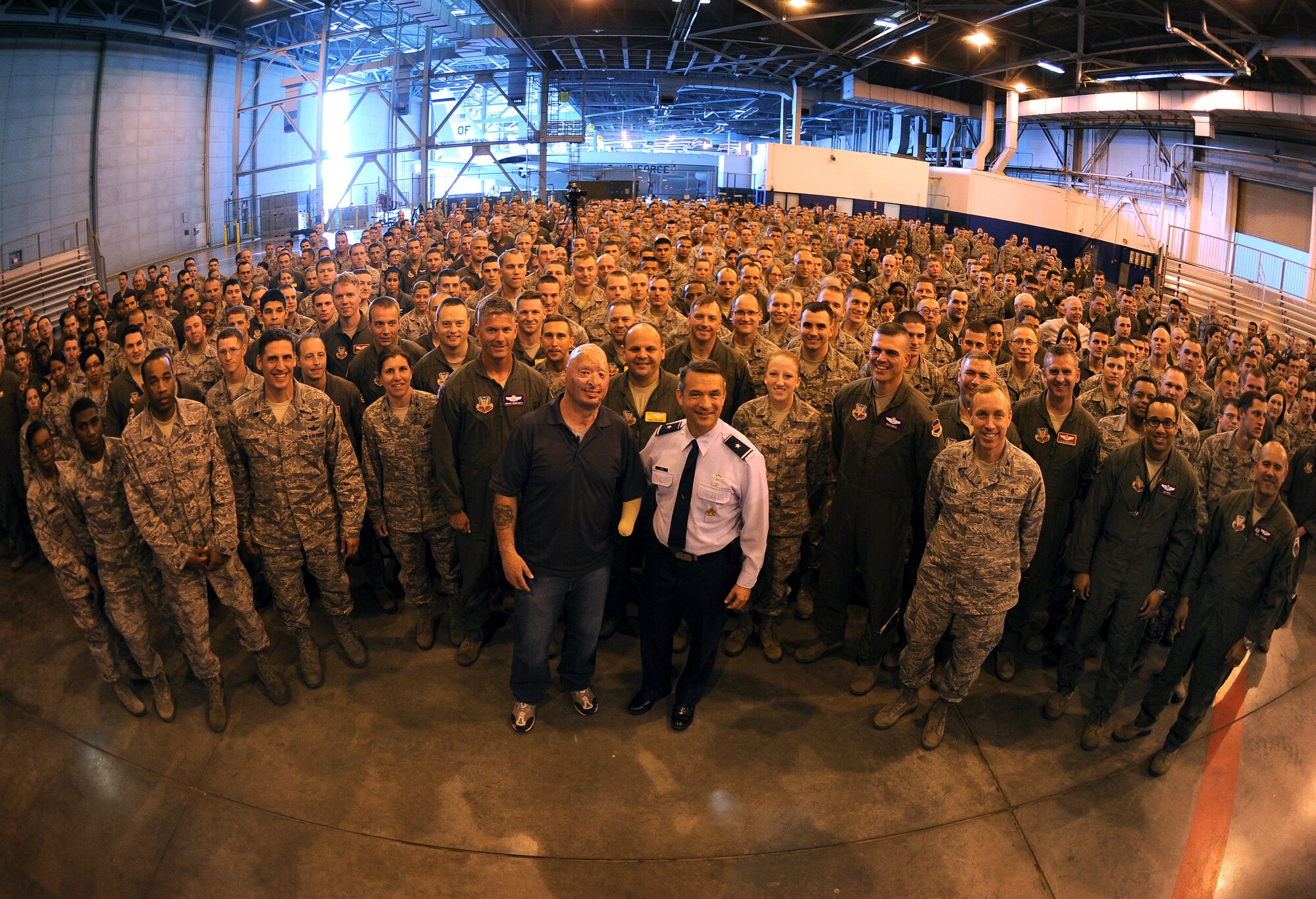 Members of Team Offutt gather around Bobby Henline, who was the guest speaker for a Special Airman's Call May 24 inside Bennie Davis Maintenance Facility on Offutt Air Force Base, Neb. (U.S. Air Force photo by Josh Plueger)