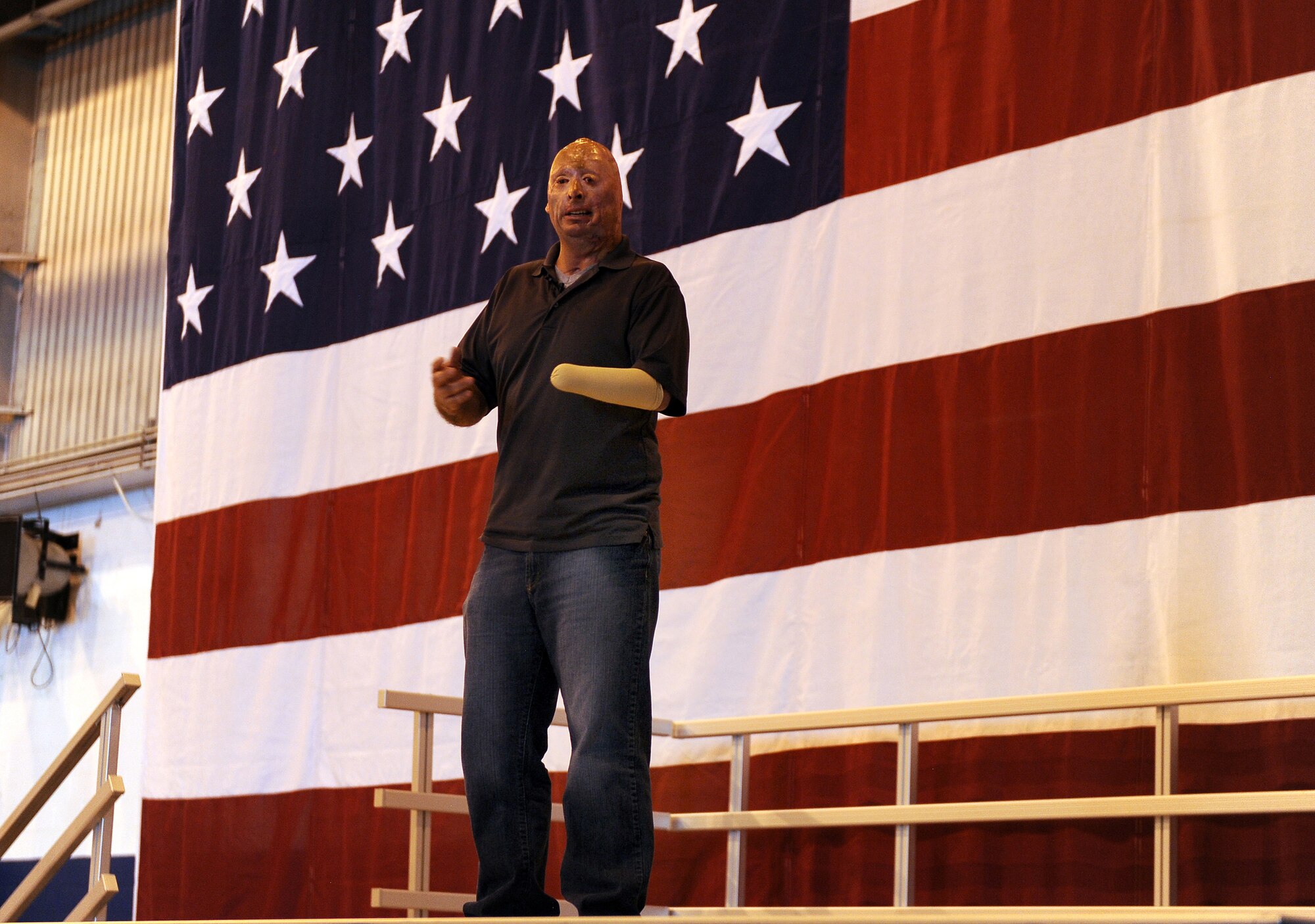 Former U.S. Army Staff Sgt. Bobby Henline talks to members of Team Offutt during a Special Airman's Call May 24 inside the Bennie Davis Maintenance Facility at Offutt Air Force Base, Neb. Henline gave both a moving story of his injuries and healing process before transitioning into his stand-up comedic act. (U.S. Air Force photo by Josh Plueger)