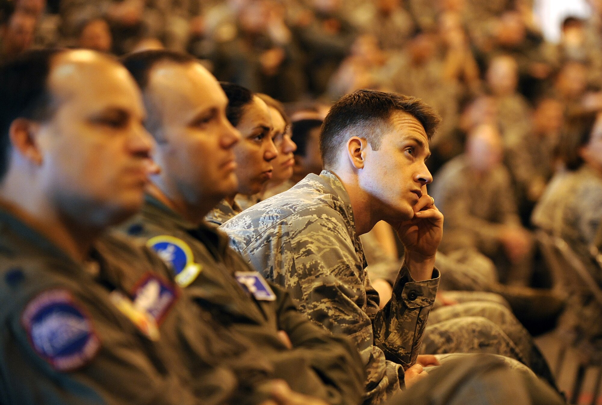 U.S. Air Force Capt. Christopher Stein, 55th Wing Legal office, attends a Special Airman's Call inside Dock 1 of the Bennie Davis Maintenance Facility May 24 at Offutt Air Force Base, Neb. Bobby Henline, a former U.S. Army staff sergeant, shared his experience of the recovery process as well as his new calling as a stand-up comedian.  (U.S. Air Force photo by Josh Plueger)