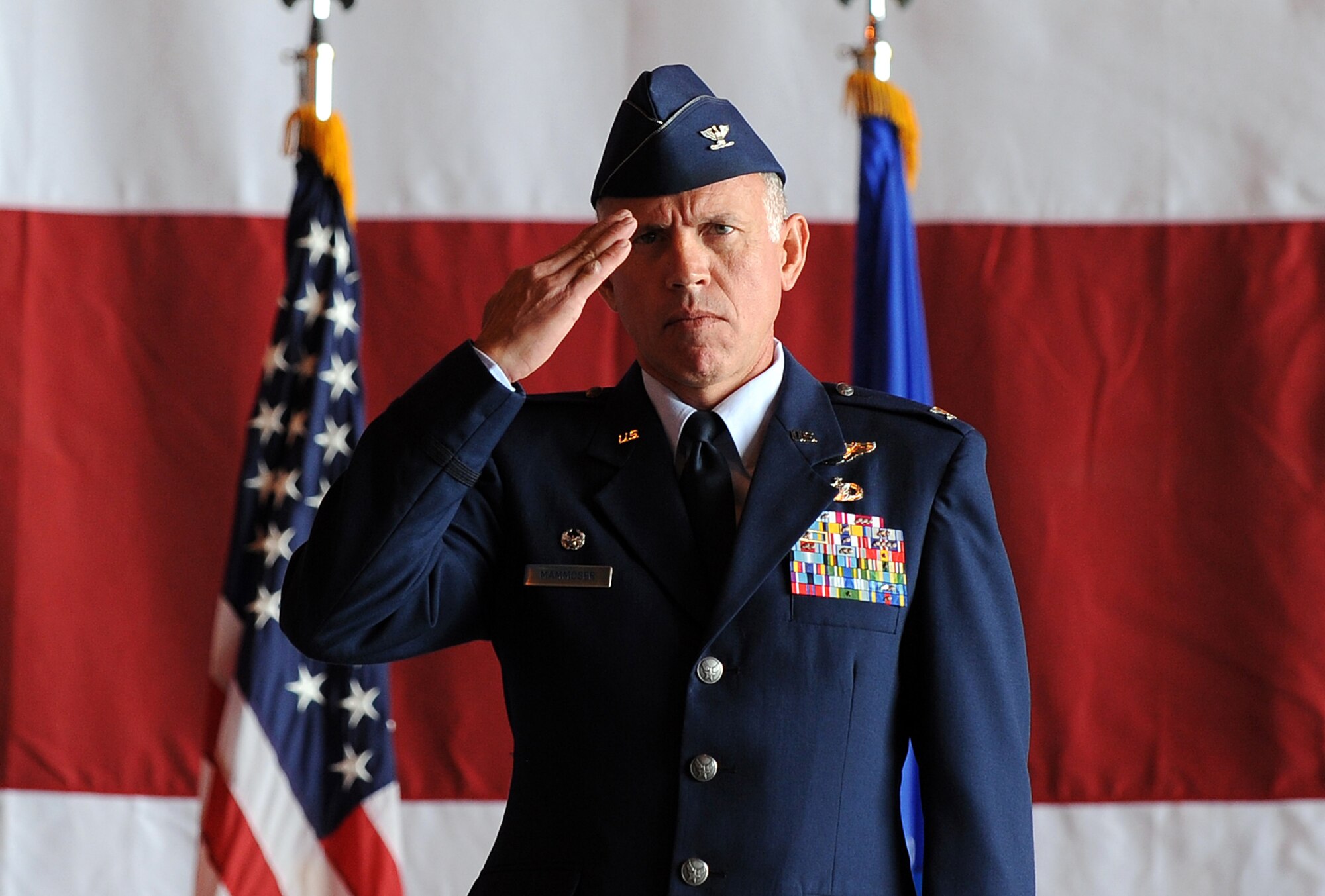 U.S. Air Force Col. Russell Mammoser, 55th Operations Group commander, gives his first salute to the Airmen of the 55th OG after accepting command of the group during a change of command ceremony held May 24 in Dock 1 of the Bennie Davis Maintenance Facility at Offutt Air Force Base, Neb. (U.S. Air Force photo by Josh Plueger)
