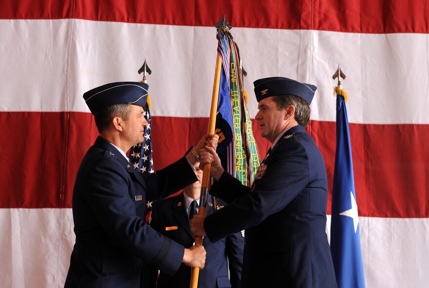 U.S. Air Force Brig. Gen. Donald Bacon, 55th Wing commander, receives the command guidon from Col. John Hansen, 55th Operations Group commander, during a formal change of command ceremony held May 24 in Dock 1 of the Bennie Davis Maintenance Facility at Offutt Air Force Base, Neb. A change of command is a military tradition that represents a formal transfer of authority from one commander to the next.  (U.S. Air Force photo by Josh Plueger)