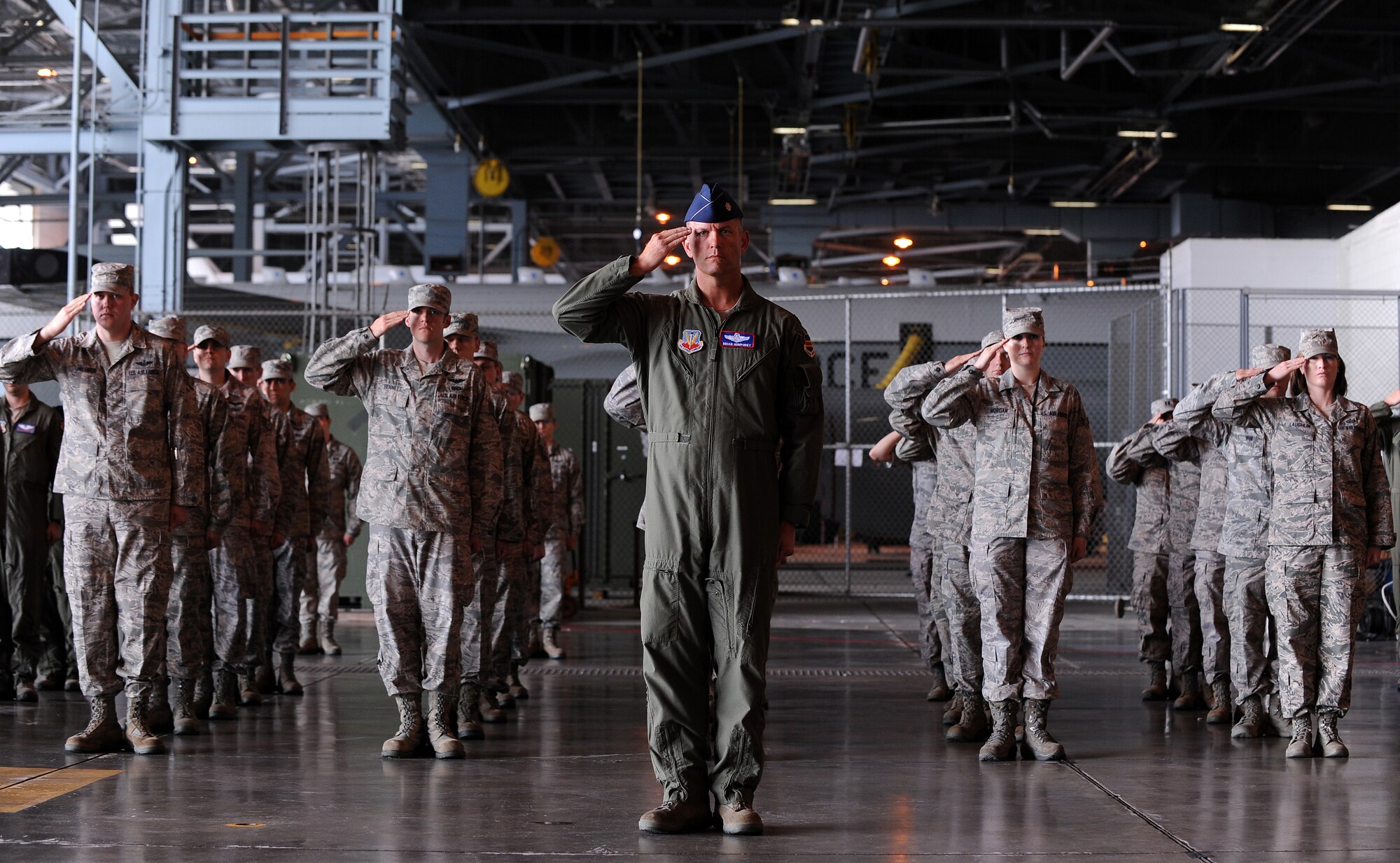 U.S. Air Force Lt. Col. Brian Humphrey, 55th Operations Group deputy commander, leads a formation of 55th OG Airmen in giving Col. John Hansen, 55th OG commander, his final salute prior to relinquishing his command at a change of command ceremony May 24 in Dock 1 of the Bennie Davis Maintenance Facility at Offutt Air Force Base, Neb.  (U.S. Air Force photo by Josh Plueger)