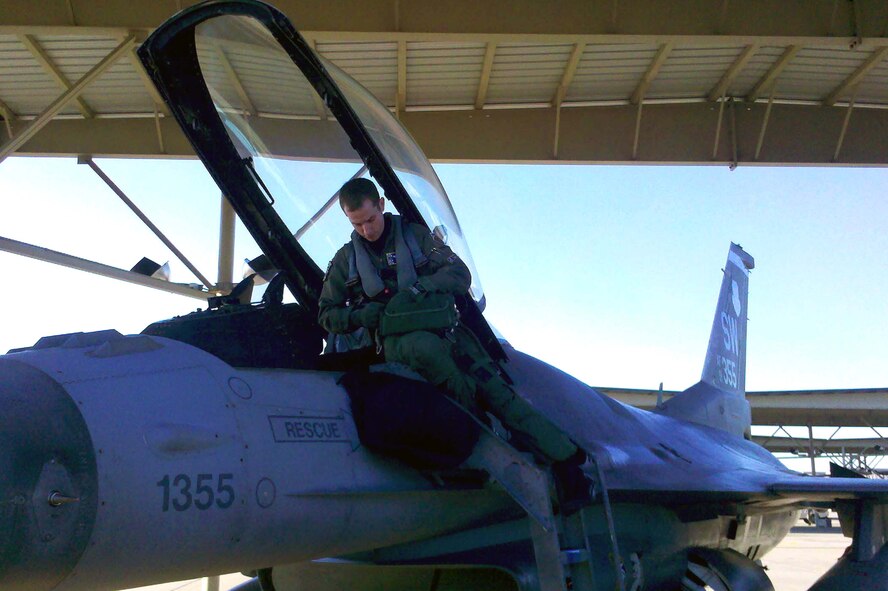 U.S. Air Force Capt. Mike Richard, 20th Operations Support Squadron, finishes pre-flight preparations on an F-16 Fighting Falcon before taking flight from Shaw Air Force Base, S.C. Richard has been named best combat tactician in the Air Force for 2011, and earned the Lt. Gen. Claire Chennault Award from the Air Force Association. In Operation Odyssey Dawn, the NATO action against Libya, he helped lead the destruction of 101 surface-to-air missiles, 120 radars, 83 missile command vehicles and 120 air defense artillery guns. (U.S. Air Force photo by Staff Sgt. Steve Pagett/Released)