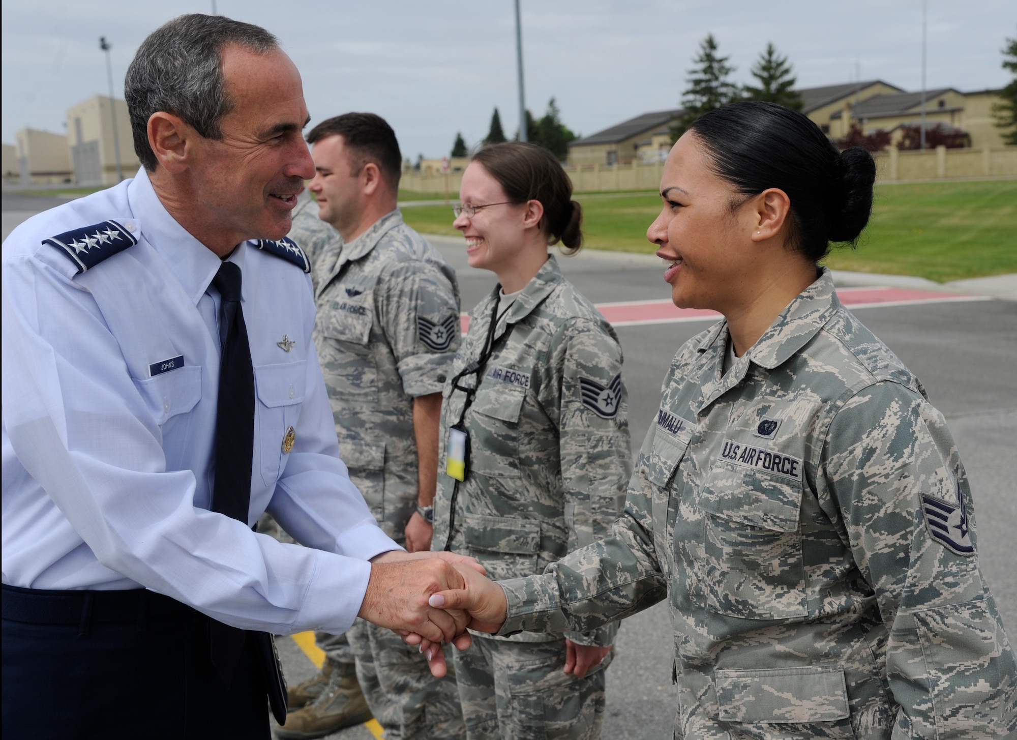 Gen. Raymond Johns, Jr., Air Mobility Command commander, greets Staff Sgt. Katelina Tiumalu, 92nd Air Refueling Wing protocol NCO in charge, during a recent visit to Fairchild Air Force Base, Wash., May 20, 2012. If something needs to be done, whether it’s picking up trash, pitching luggage or washing vehicles and someone else hasn't done their job, then the wing’s protocol office is there getting the mission done. (U.S. Air Force photo by Airman 1st Class Ryan Zeski/Released)