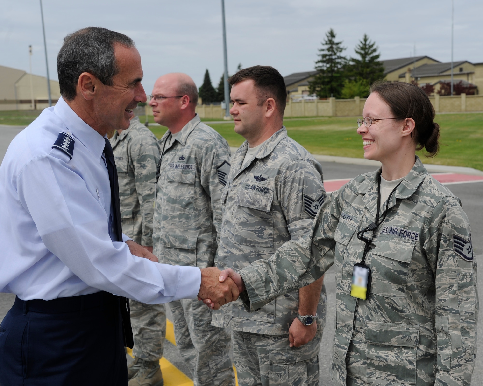 Gen. Raymond Johns, Jr., Air Mobility Command commander, greets Staff Sgt. Christine Tooth, 92nd Air Refueling Wing protocol specialist, during a recent visit to Fairchild Air Force Base, Wash., May 20, 2012. If something needs to be done, whether it’s picking up trash, pitching luggage or washing vehicles and someone else hasn't done their job, then the wing’s protocol office is there getting the mission done. (U.S. Air Force photo by Airman 1st Class Ryan Zeski/Released)